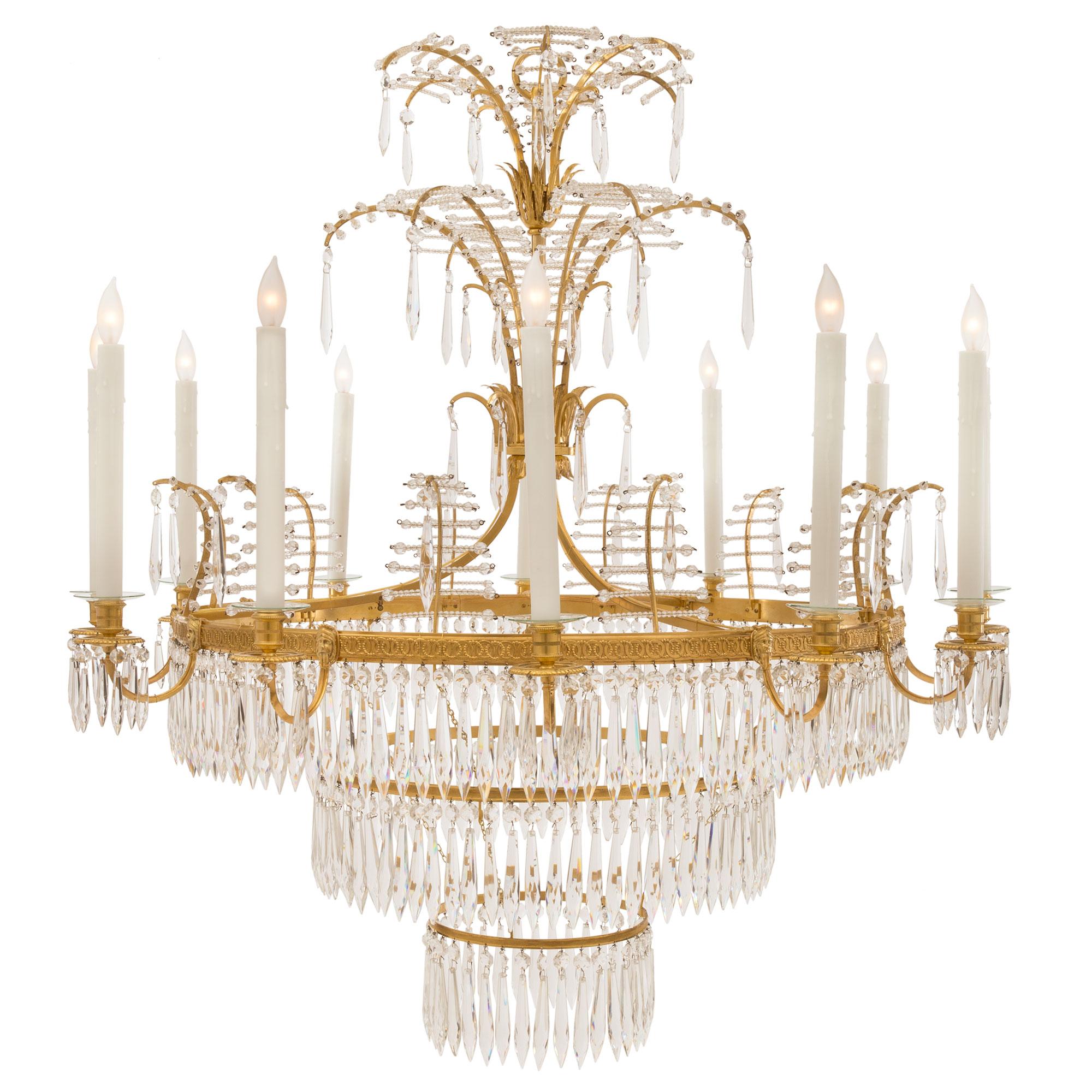 A stunning Russian early 19th century neo-classical st. ormolu and crystal chandelier. The ten arm chandelier is centered by an elegant stepped design with three circular hanging tiers adorned with fine prism shaped cut crystal pendants. The central