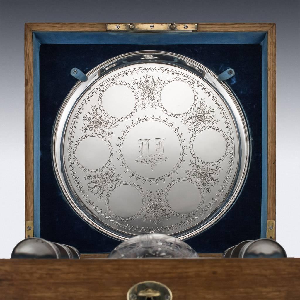 Antique 19th century Imperial Russian eight-piece solid silver and cut-glass vodka set, comprising: a circular tray engraved with Lillis of the valley and place circles, the baluster shaped bottle etched with flowers and leaves, collar and stopper