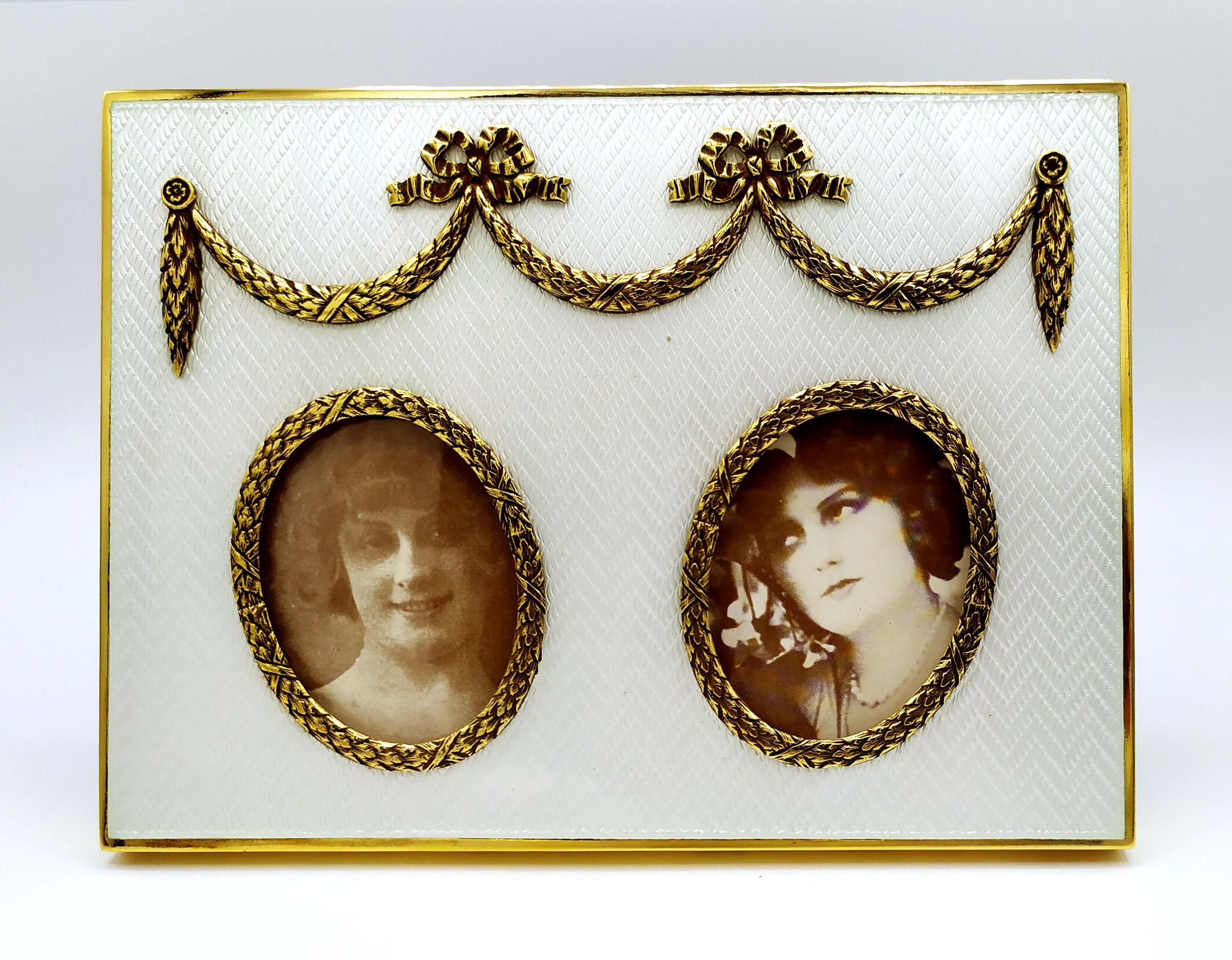 Rectangular photo frame in 925/1000 sterling silver gold plated with translucent fired enamel on guillochè with 2 oval borders internal size cm. 4 x 5.2 and ornaments with festoons and bows in Russian Empire Fabergè style. External cm. 12 x 16.3.
