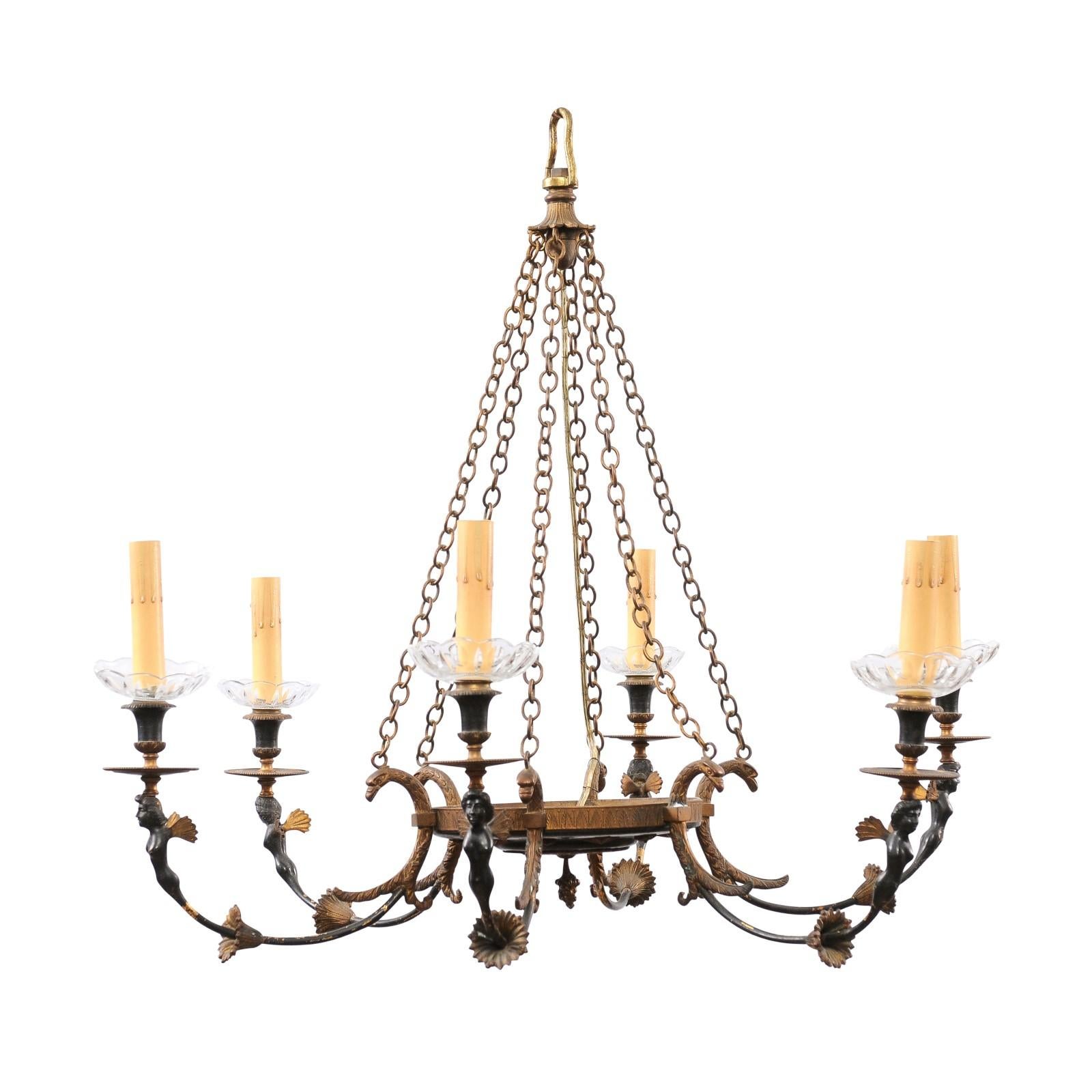 A Russian Empire style black and gold bronze chandelier from the 20th century, with six lights, classical figures and foliage motifs. Created in Russia during the 20th century, this Empire style chandelier features a central basket connected to the