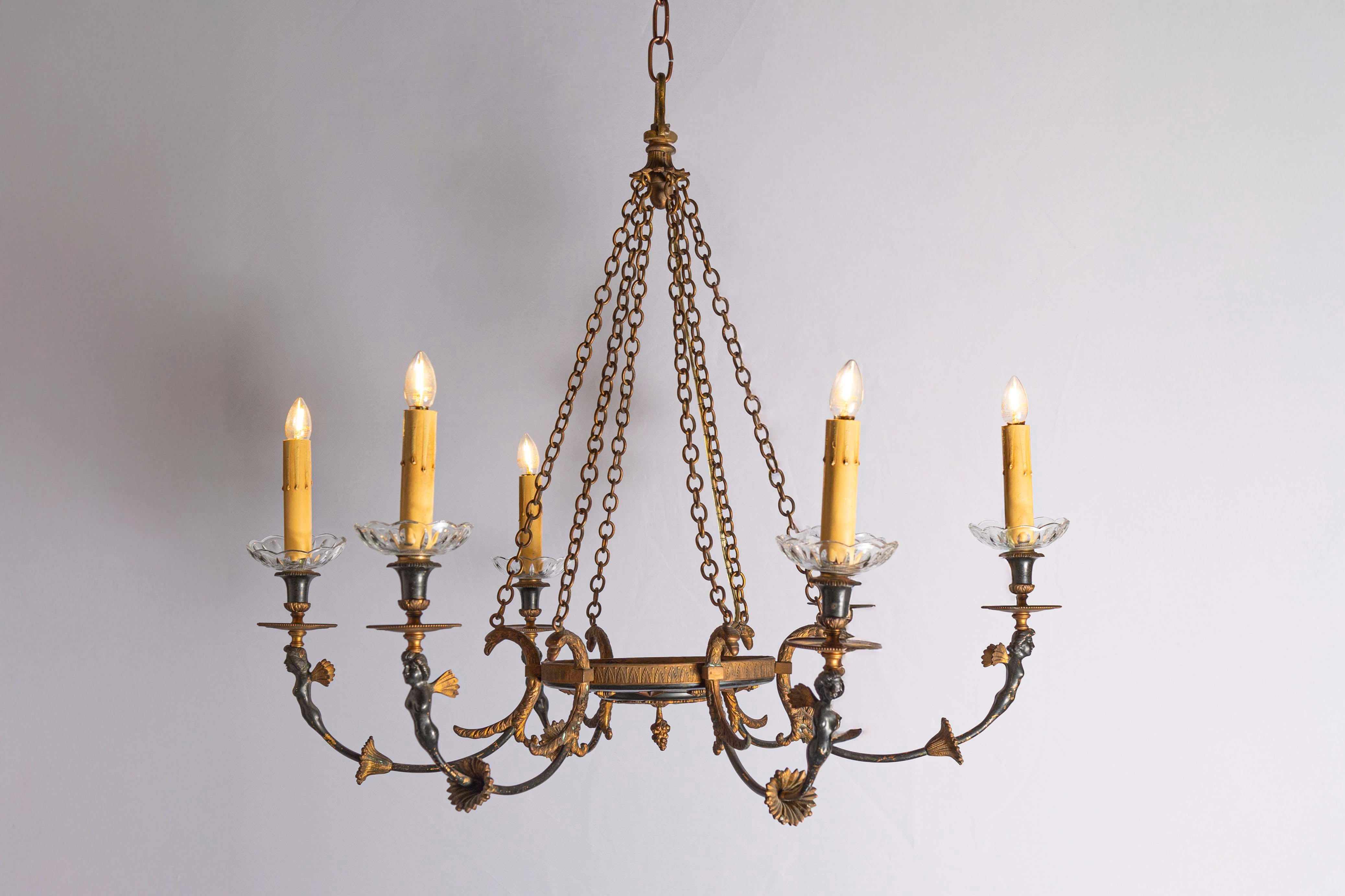 A Russian Empire style black and gold bronze chandelier from the 20th century, with six lights, classical figures and foliage motifs. Created in Russia during the 20th century, this Empire style chandelier features a central basket connected to the