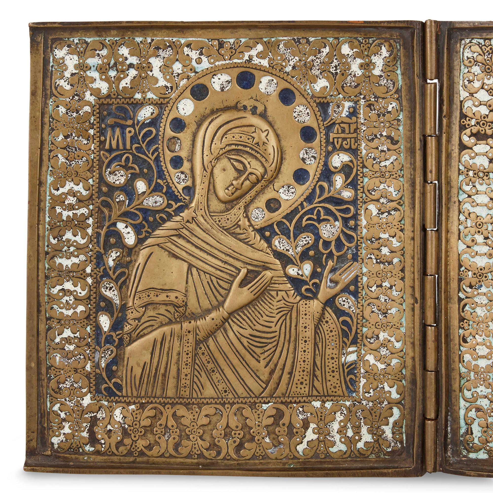 This three-panel folding icon, a triptych, is wrought from bronze and enamel. The three panels contain religious images: the central panel portrays Christ, while the flanking panels portray saints. The figures, articulated in bronze relief, are