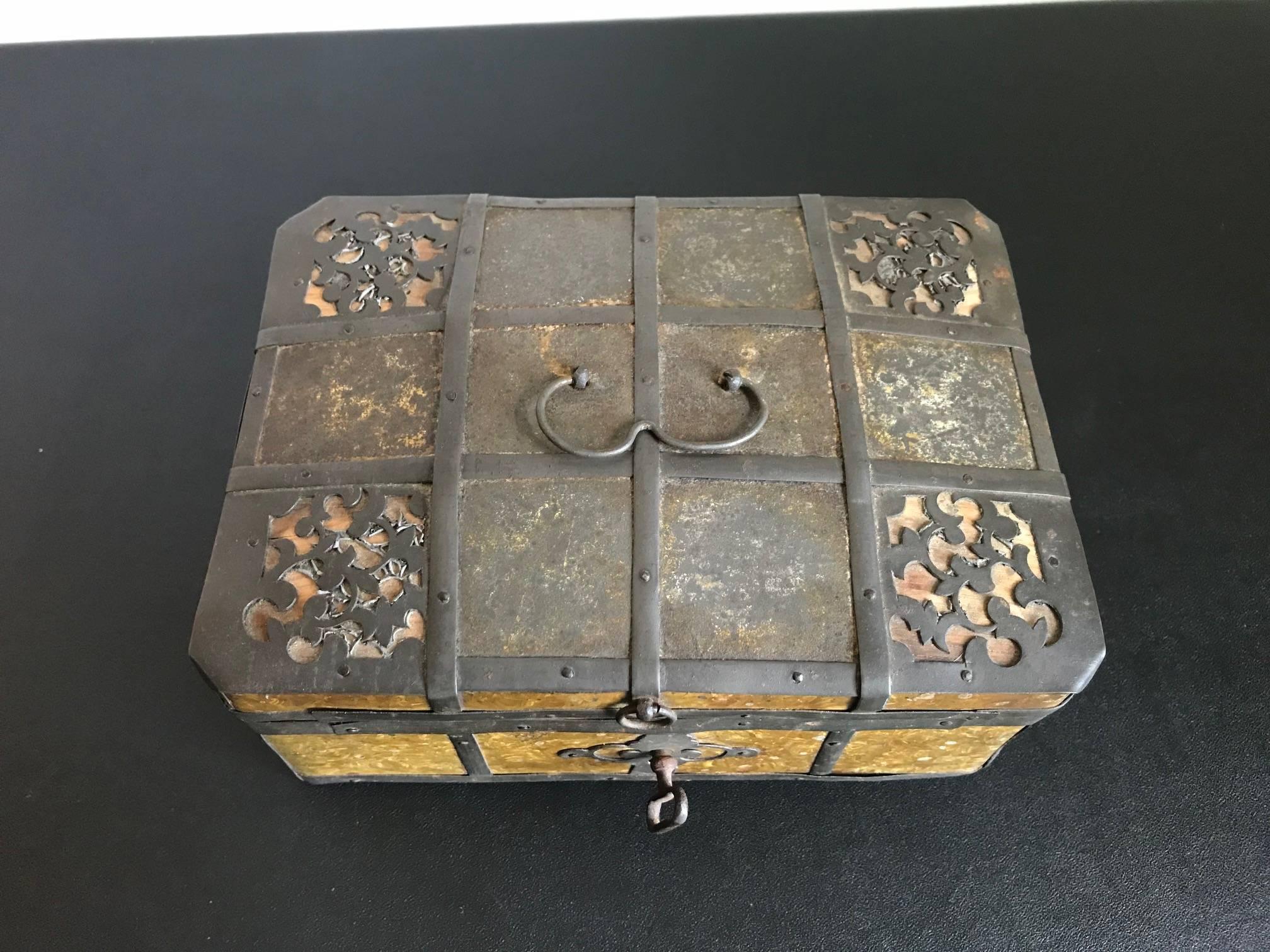 A rare early 19th century Russian iron-bound box decorated with gilt metal 'Frost' pattern. The beautiful gold panels meant to mimic frost on glass. Retaining the original key, the lock in working order, it makes an usual musical tone when the key