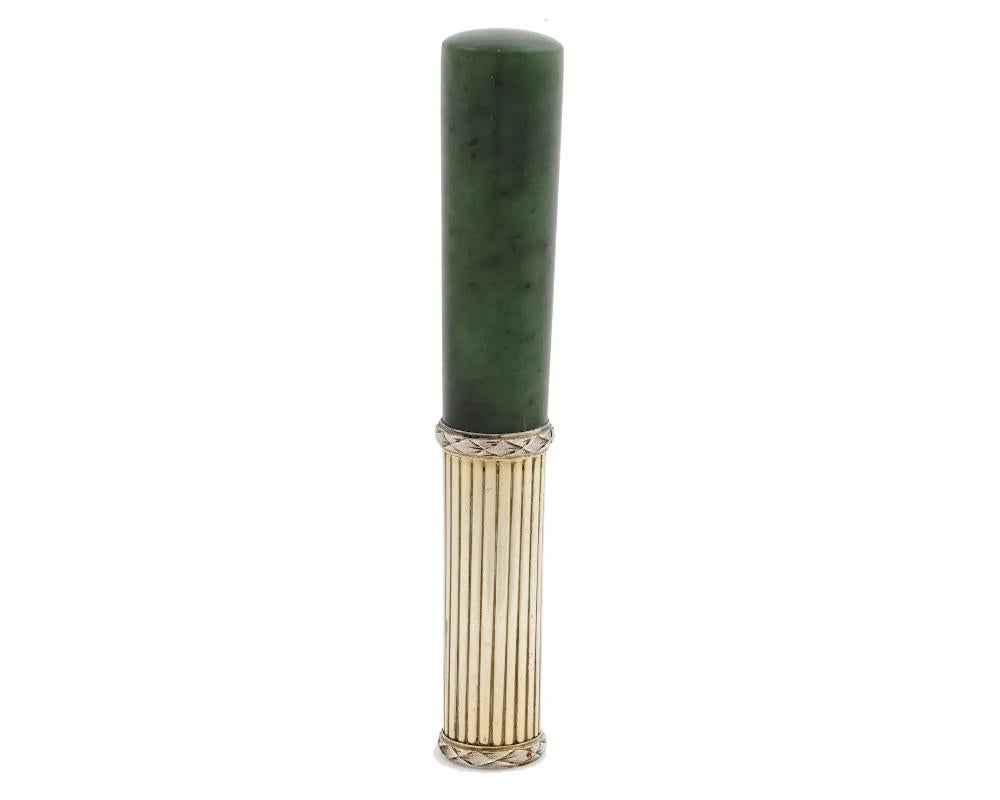 An elegant Russian carved jade parasol cane handle mounted in a gilt silver setting with hand engraved stripes to the body and laurel wreath motifs to the rims. Hallmarked with an 84 Russian Imperial silver standard, a kokoshnik mark and the