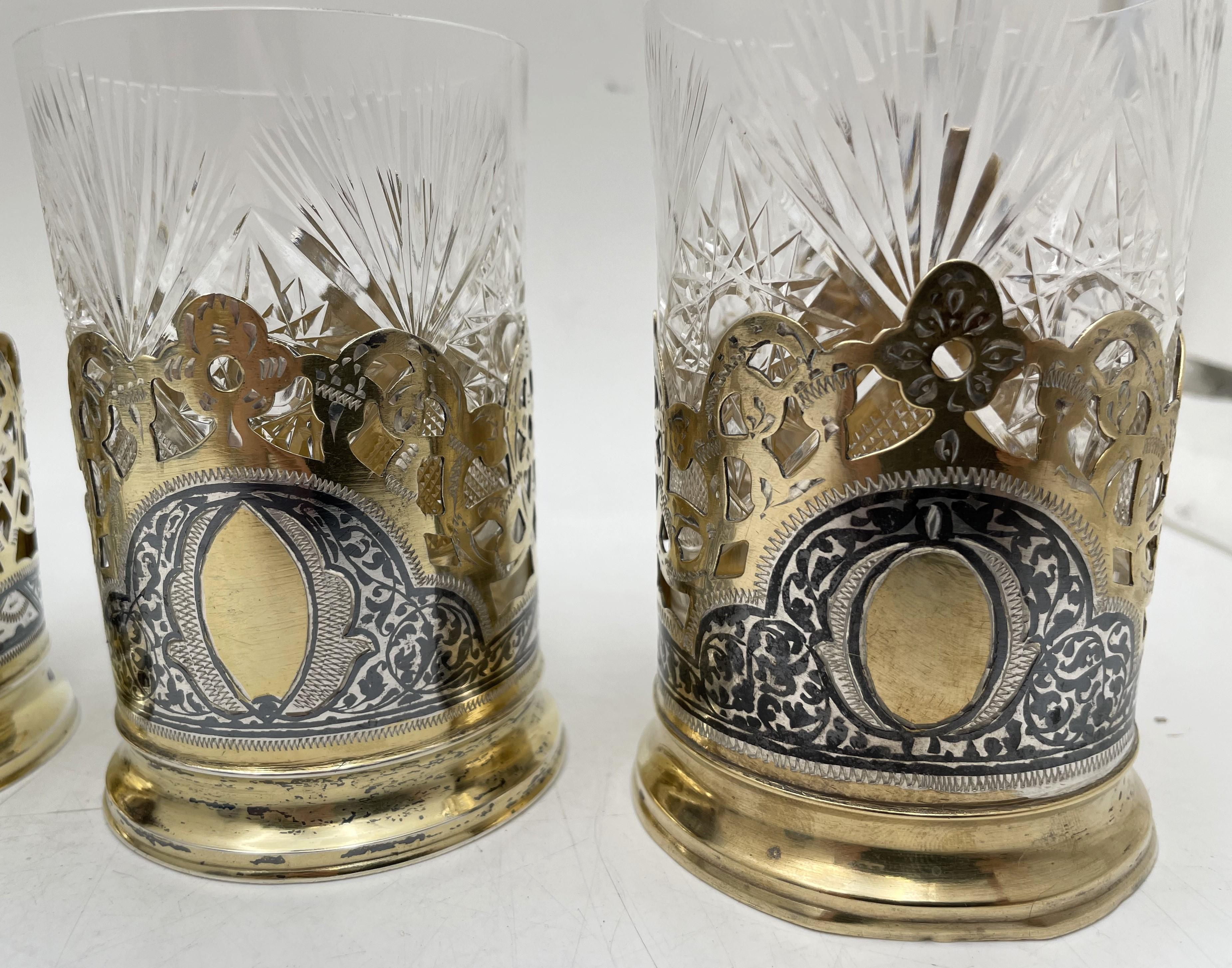 Russian gilt 0.87 silver and enamel/ niello set of 6 cups with a beautiful, intricate, geometric and floral design from the 20th century. Fitted glass liners enhance the beauty of these cups. The cups measure 3 7/8'' in height (height with the liner