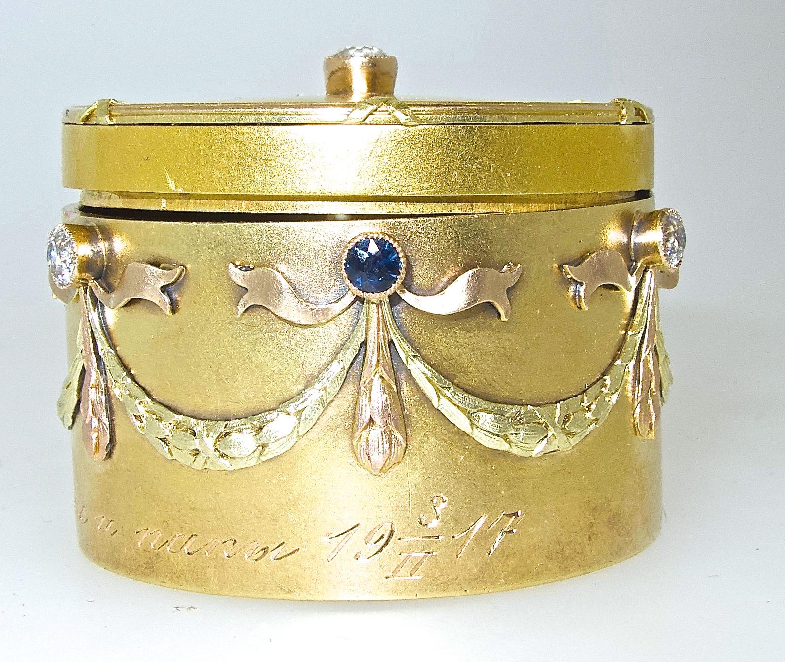 Russian tried color gold, with a satin like finish, small box inscribed Merry Christmas from Mom and dad 1917, with old cut diamonds, estimate ti weigh .85 cts., and 3 round natural blue sapphires.  Numbered and with Russian hallmarks and the gold