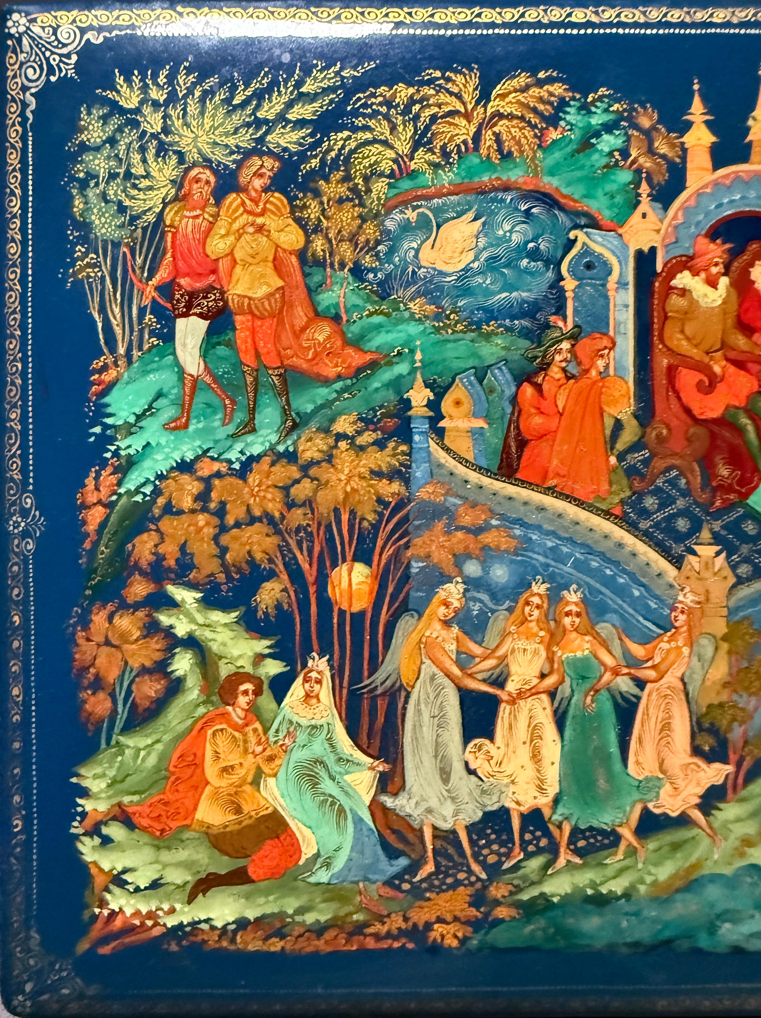 A finely crafted Russian hand-painted lacquer box, likely depicting a scene from Swan Lake. Rendered in the traditional Palekh style, the composition features graceful dancers, courtiers, and a central swan motif set within an opulent fairytale