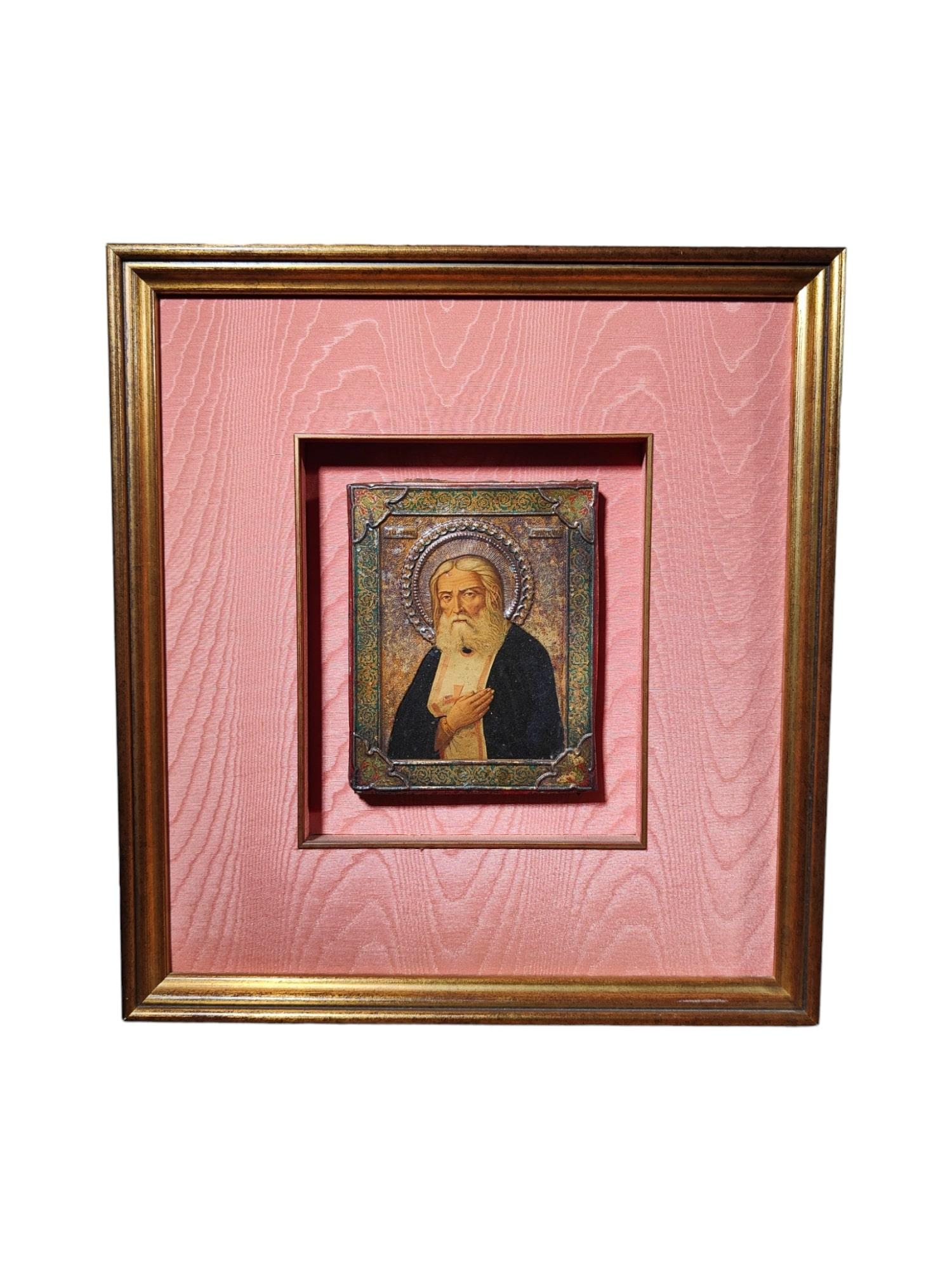 Type: Decorative Russian Icon
Era: 19th Century
Material: Painted on Metal Plate and Framed
Dimensions: 45 x 40 cm (main icon), 18 x 14 cm (smaller icon)
Features and Details:
This decorative Russian icon hails from the 19th century, showcasing