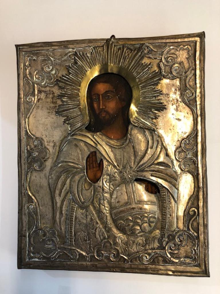 This impressive icon is encased in a metal oklad (?????) with Riza (????) as the halo around christ’s head. Oklad means “covered