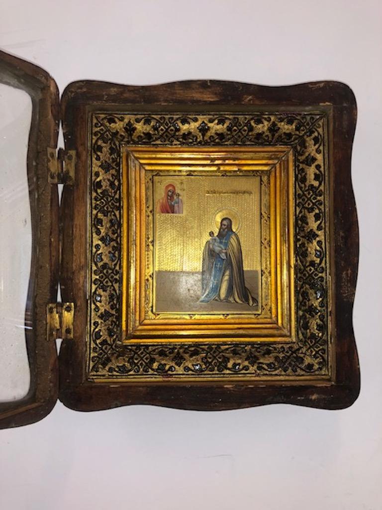 Icon of Saint Julianus - Protector
 of Children

 Icon is done with oil paint with a gold leaf background on the wood panel. It is framed with double wooden frame and placed in a box (kiot) with original glass front. 

 Russia, circa