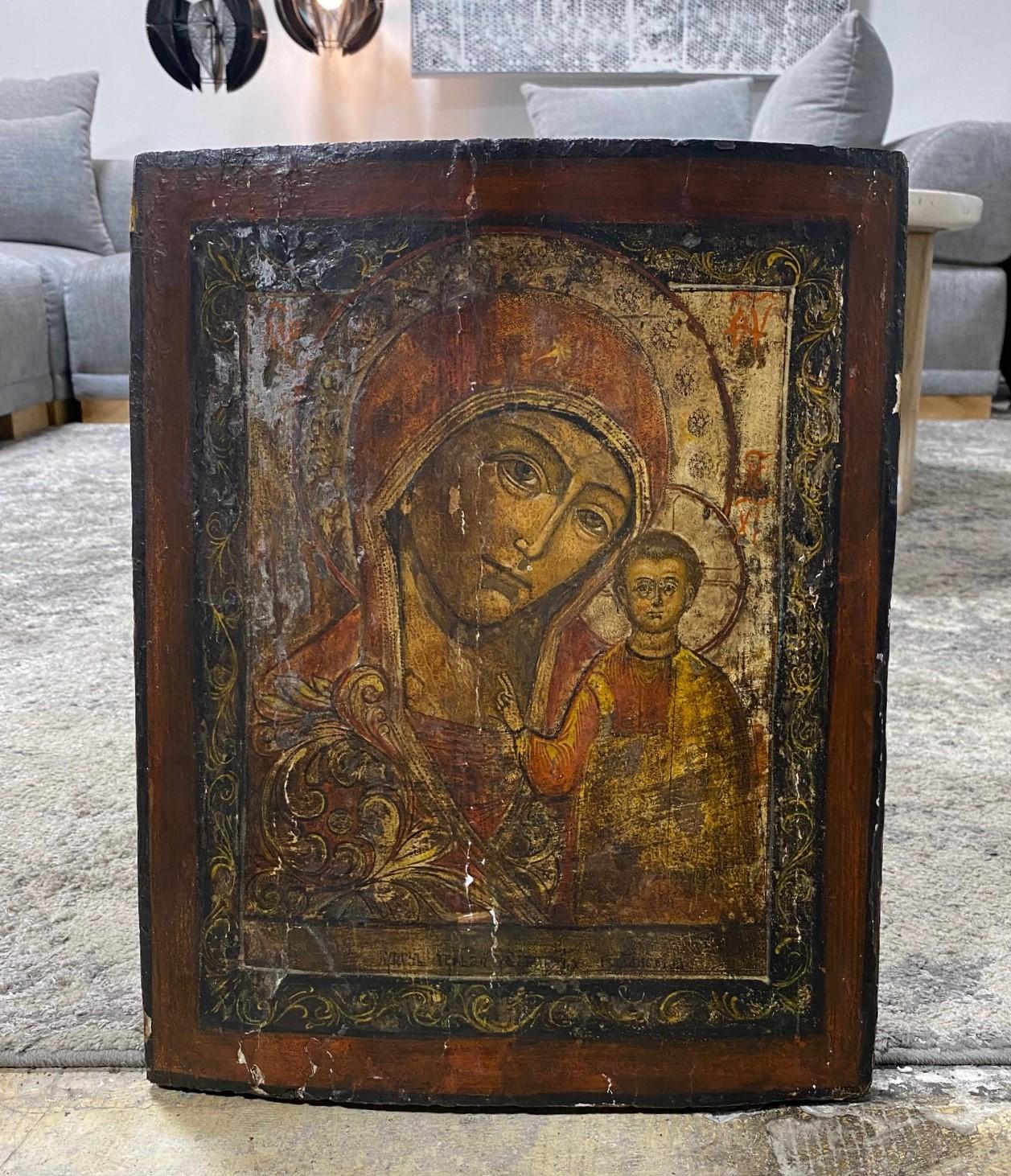 A beautifully engaging, darkly nuanced Theotokos of Vladimir Russian icon (or possibly Our Lady of Kazan Icon/Mother of God of Kazan) tempera painting (and possibly gold leaf) on a wooden panel featuring the Madonna (Mother Mary) and infant child (a