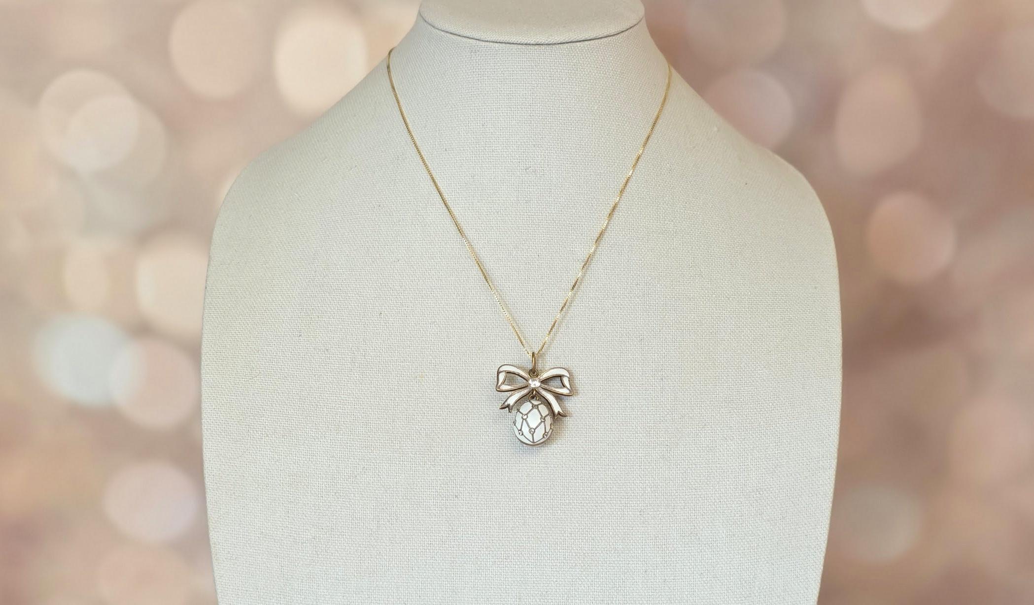 Presenting an exquisite egg-shaped pendant crafted from Russian Imperial 84-zolotnik silver, adorned with gold plating and enamel. This delicate piece features a raised lattice design with imitation diamonds (such as cubic zirconia (CZ) or