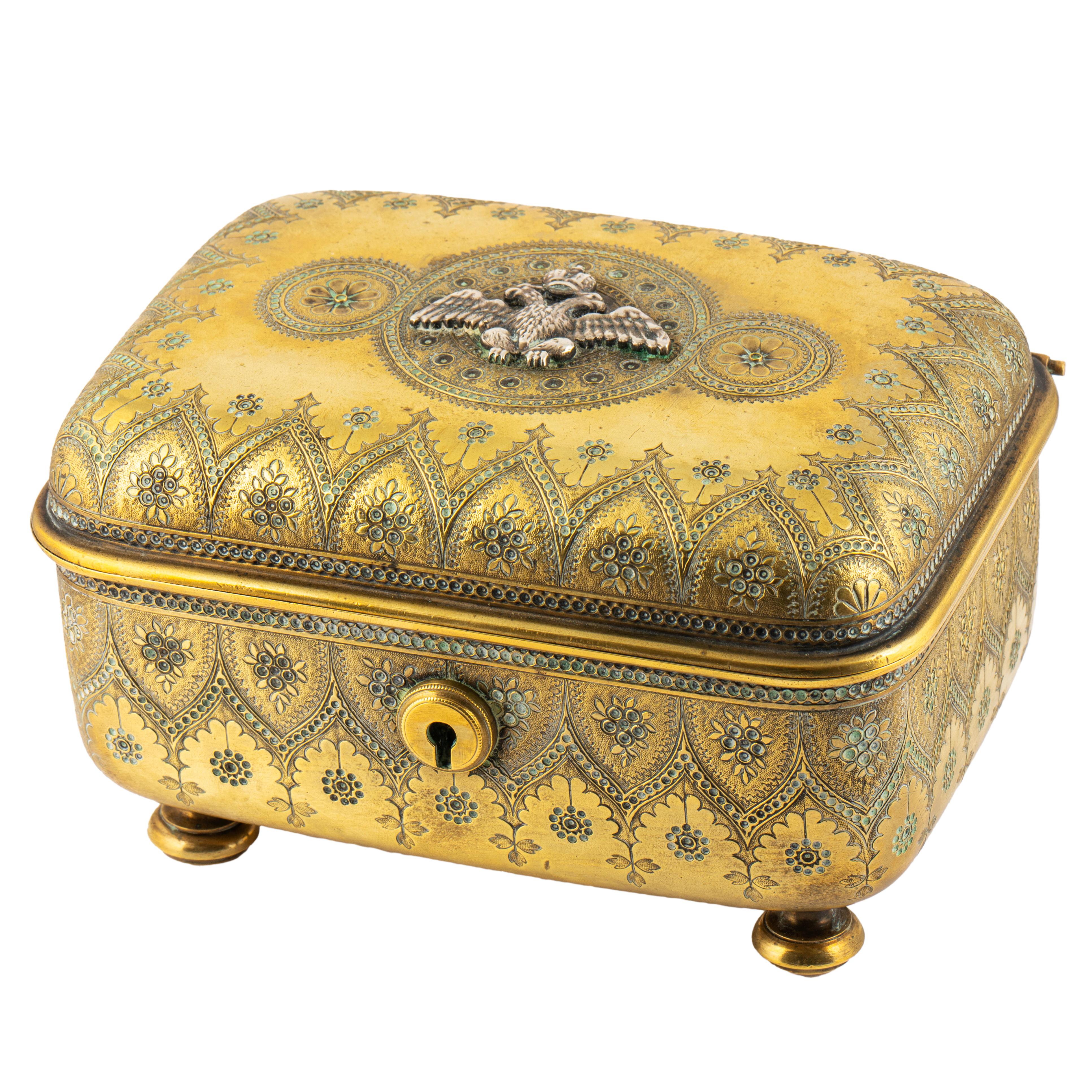 Beautiful Russian brass and silver imperial trinket box from the Romanov era, period of Tsar
Nicholas II, rectangular with rounded corners, the borders and sides decorated with intricate 
floral and peaked arch motifs, the cover applied with a