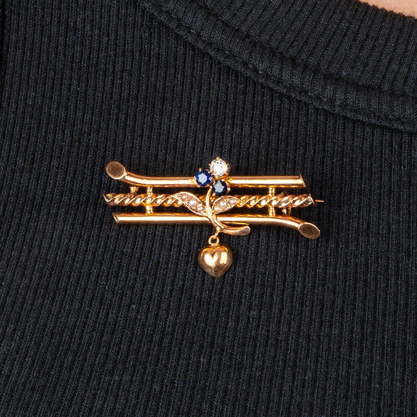 A rare gold pin from the Romanov era, period of Tsar Nicholas II, designed as horizontal gold bands, the middle one of ropework design, applied with a sapphire and diamond trefoil-symbol of the Holy Trinity in the Russian Orthodox religion-the