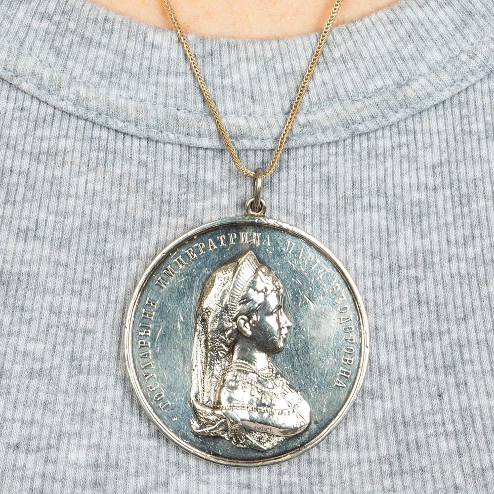 Beautiful solid silver medallion mounted as a pendant from the Romanov era, period of Alexander III, on one side is a portrait bust of Empress Maria Feodorovna (1847-1928), wife of the Russian Tsar. The other side depicts a figure standing with