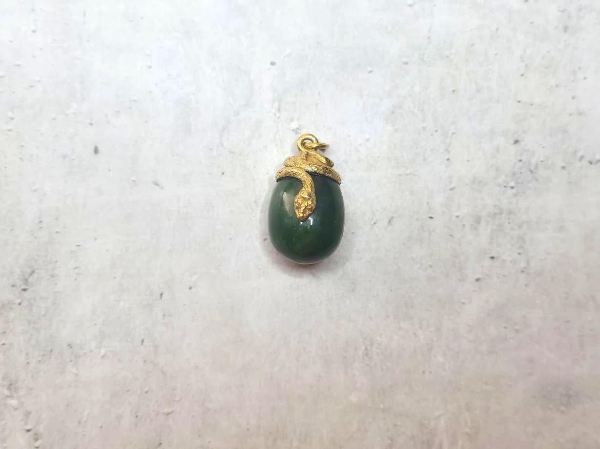 We are delighted to present another unique piece from our collection—a miniature egg pendant by the jeweler Henrik Wigström.

This exquisite pendant is crafted in the form of a jade egg entwined with a gilded snake. The suspension ring bears several