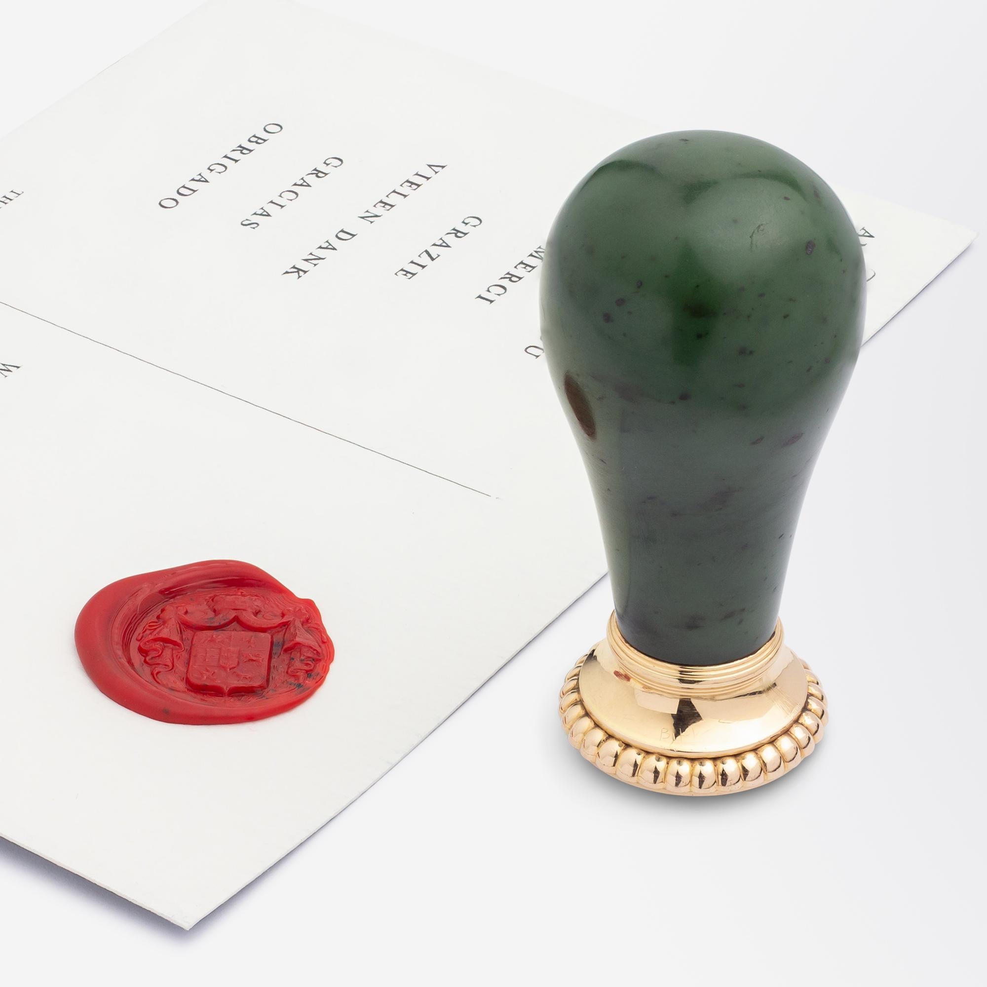 This magnificent desk seal dates to Russia pre the 1917 revolution and is crafted from nephrite jade, gold and a carved white chalcedony intaglio. The pommel form nephrite jade handle sits above a gold mount which has gadrooning to the rim and