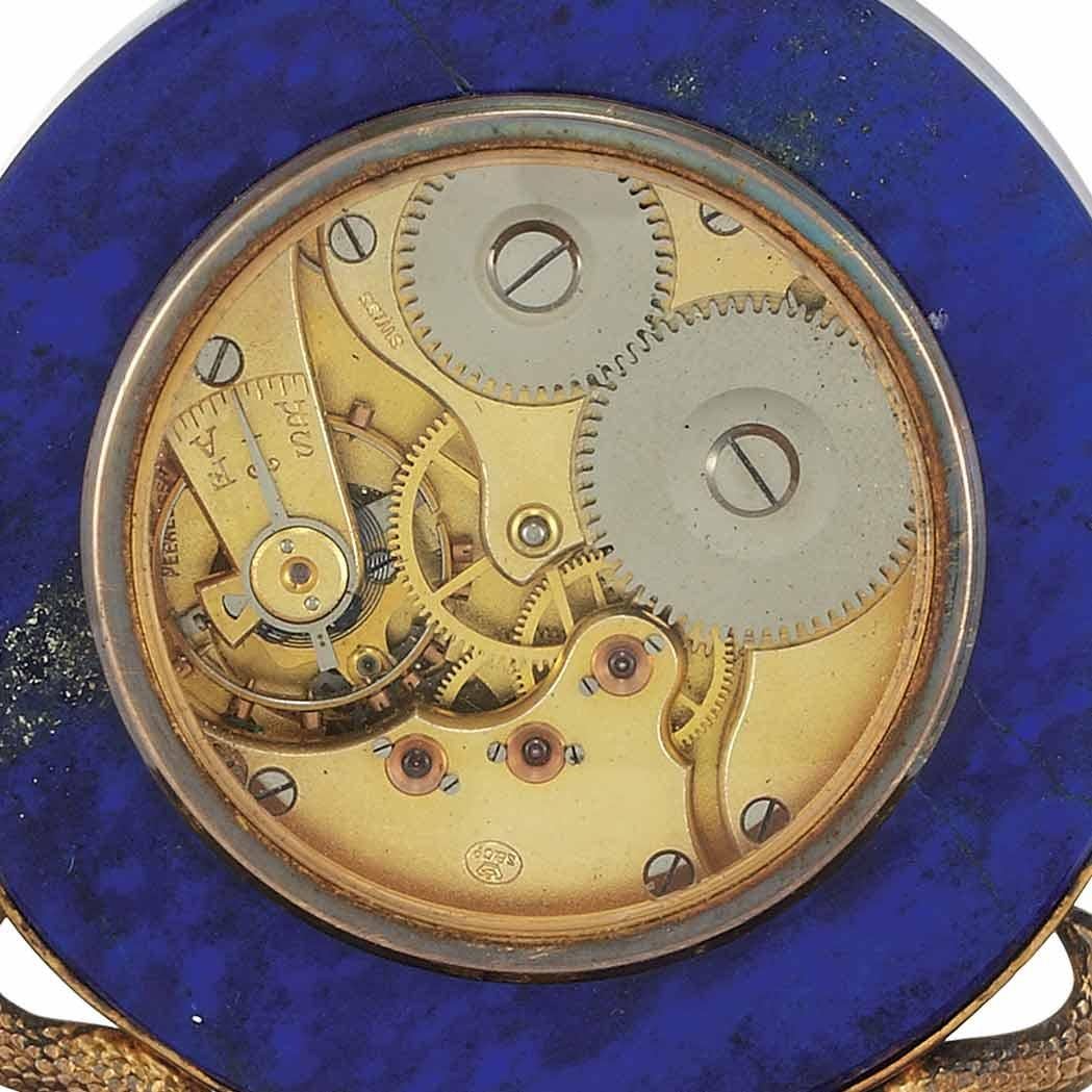 This magnificent old desk clock is an antique collector's dream. The details on this desk clock are beautiful. It is designed with Russian Lapis and Gilt-silver, paired with a white porcelain Arabic numeral dial with sunk seconds surrounded by a