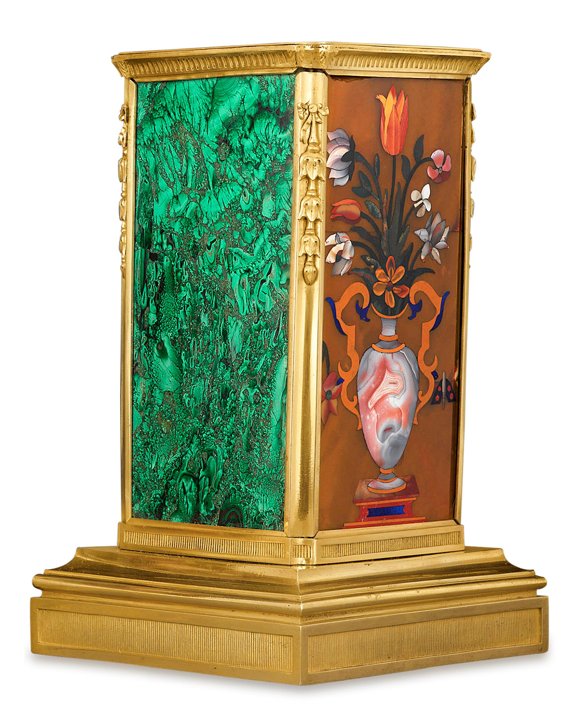 The exquisite art of pietre dure is at its absolute finest in this spectacular pair of Russian ormolu and malachite plinths. True works of art of the Restauration period, these plinths each feature a matching pietre dure mosaic crafted of the finest