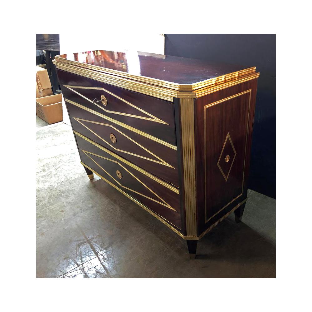 A fine Russian neoclassic mahogany three-drawer commode with brass trim and mounts, with diamond-shaped inlays and a stepped top, raised on canted square tapered legs.