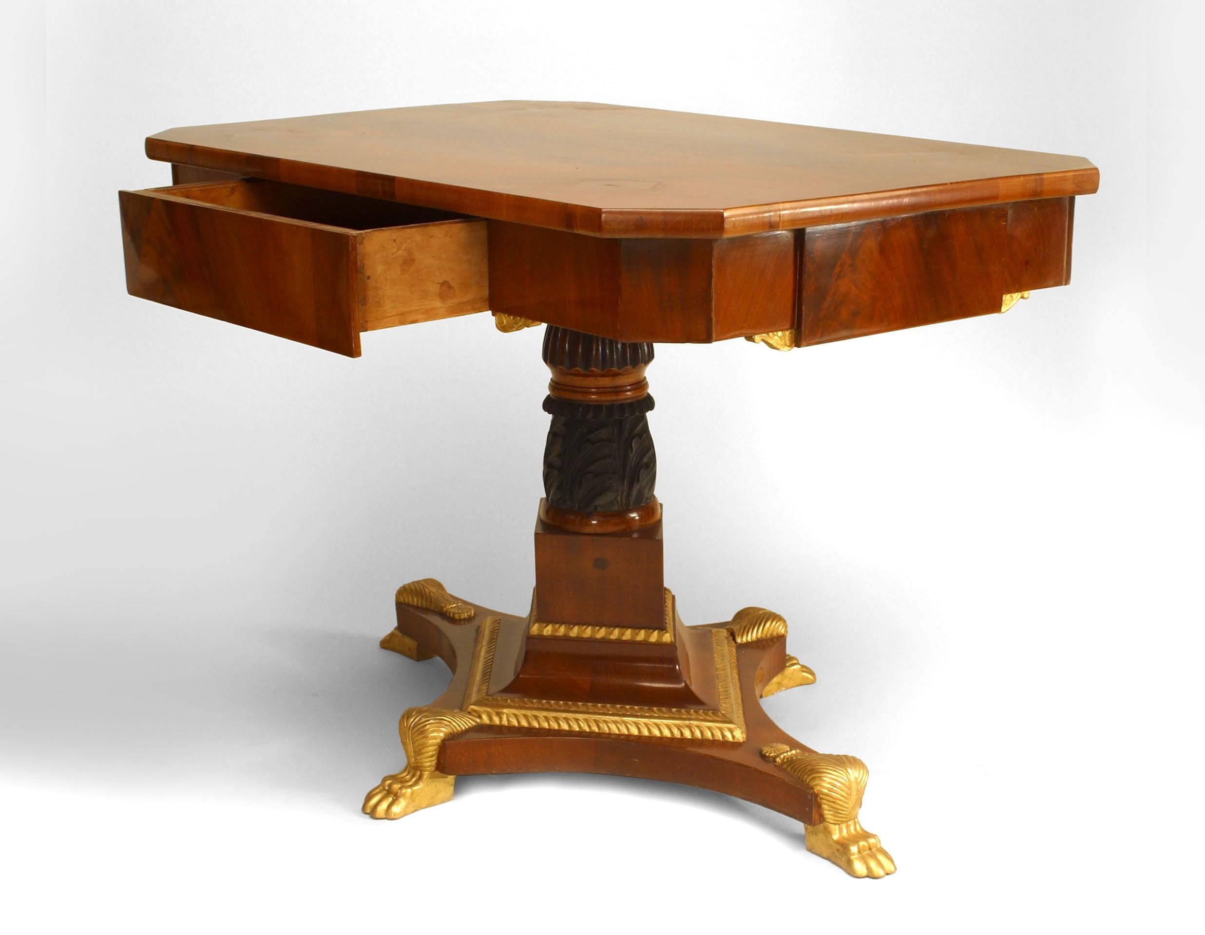 Russian Neoclassic (19th Century) parcel gilt & ebonized mahogany center table with a frieze drawer on an acanthus carved stem and quadripartite base with claw feet.
