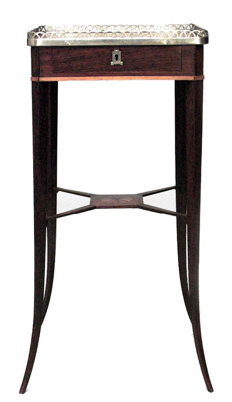 Russian Neoclassic-style mahogany side table with brass gallery over a frieze drawer and splayed legs joined by a fan parquetry inlaid stretcher.
