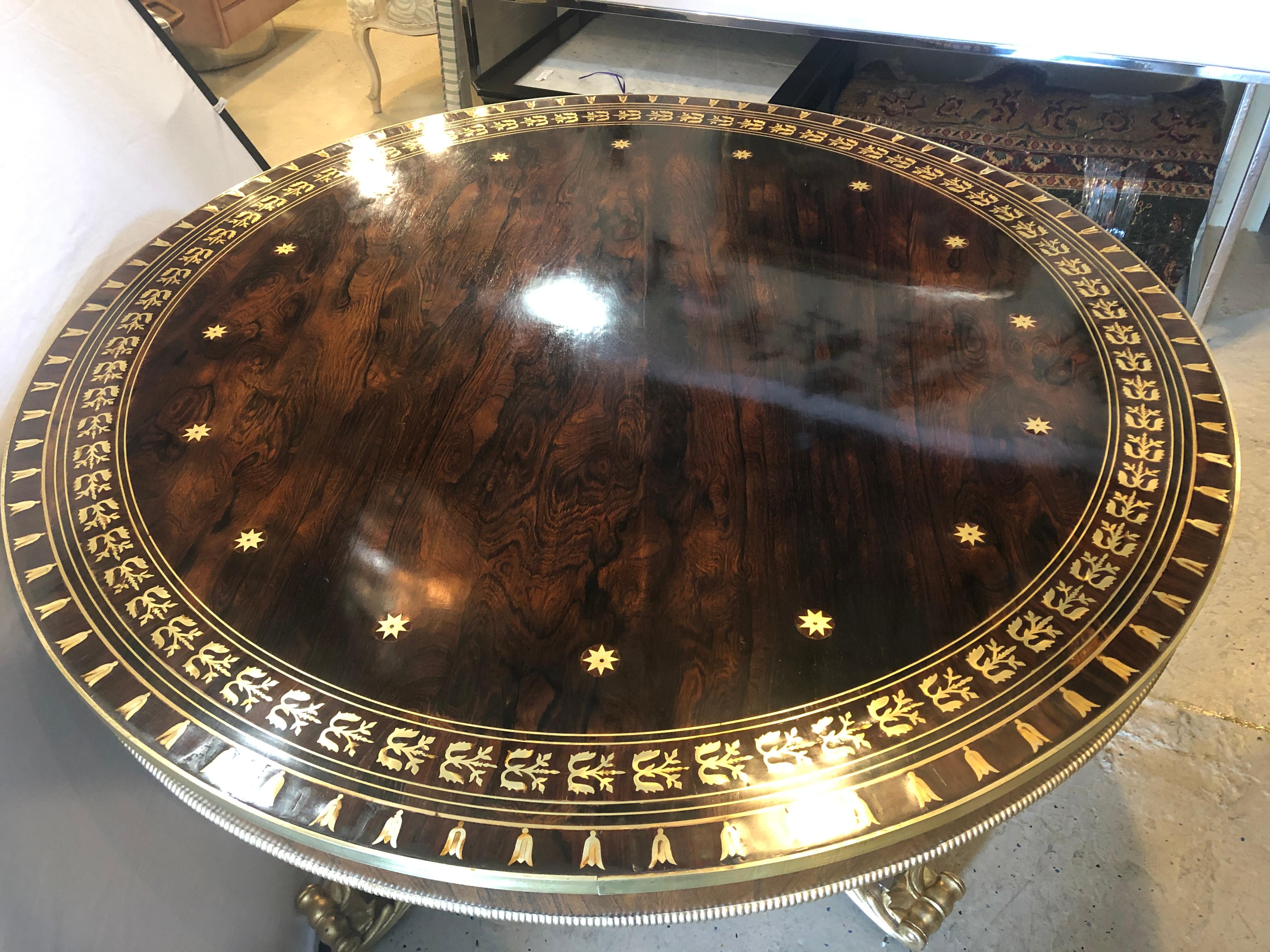 Early Russian neoclassical early 19th century rosewood breakfast / center / dining table. The show stops here. The is simply the finest in craftsmanship. The gilt gold reverse claw feet on a boule inlaid base with gilt column center pedestal in