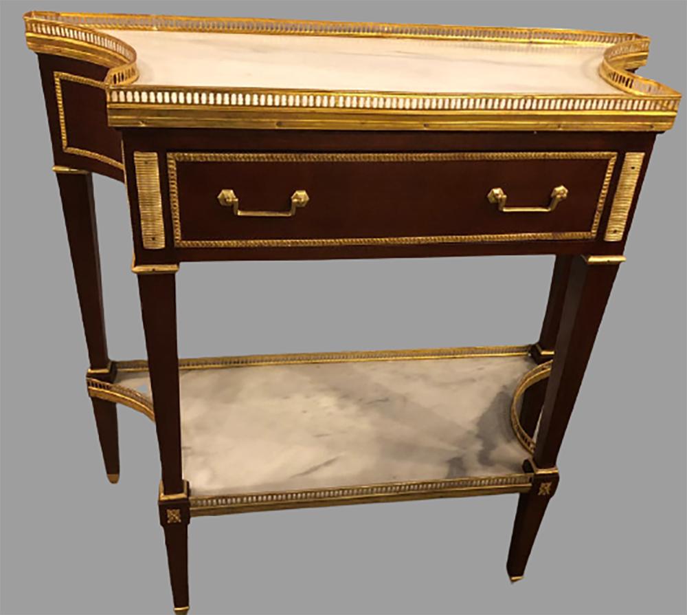 Russian neoclassical style console with inverted sides and marble top. This fine Maison Jansen inspired console table or serving table depict the glamour of the Hollywood Regency era at its height. Having tapering legs with bronze mounts leading to