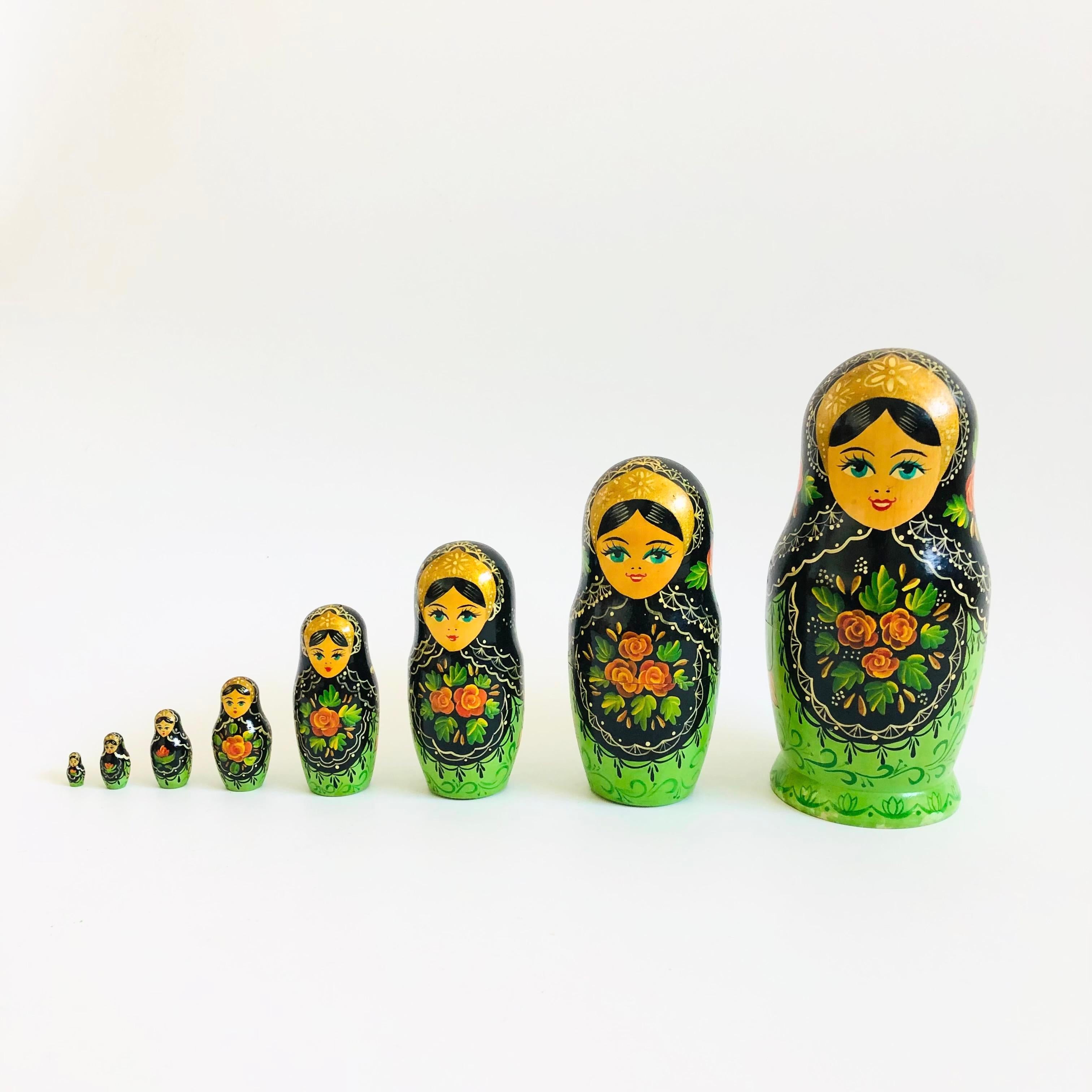 A wonderful vintage wood Russian Matryoshka, set of 8 nesting dolls. Great hand painted detailing and natural wood tones coming though. Signed Ceprueb Nocag on the base.

