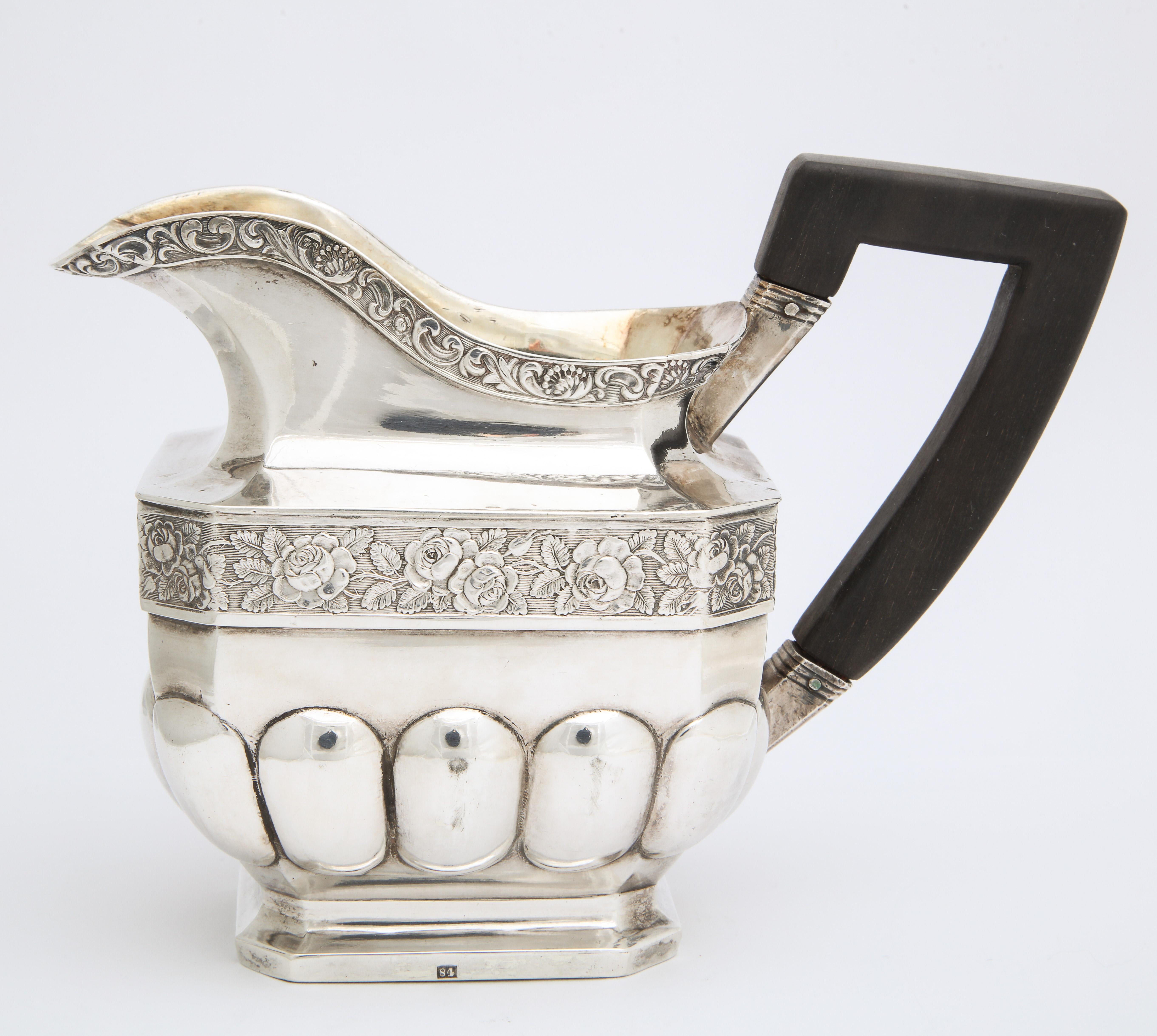 From the Romanov era, period of Tsar Nicholas I (1825-55), this large silver cream jug was made in the ancient capital of Moscow. Of rectangular outline with canted corners, the lobed lower section below a central band of repoussé flowers, the