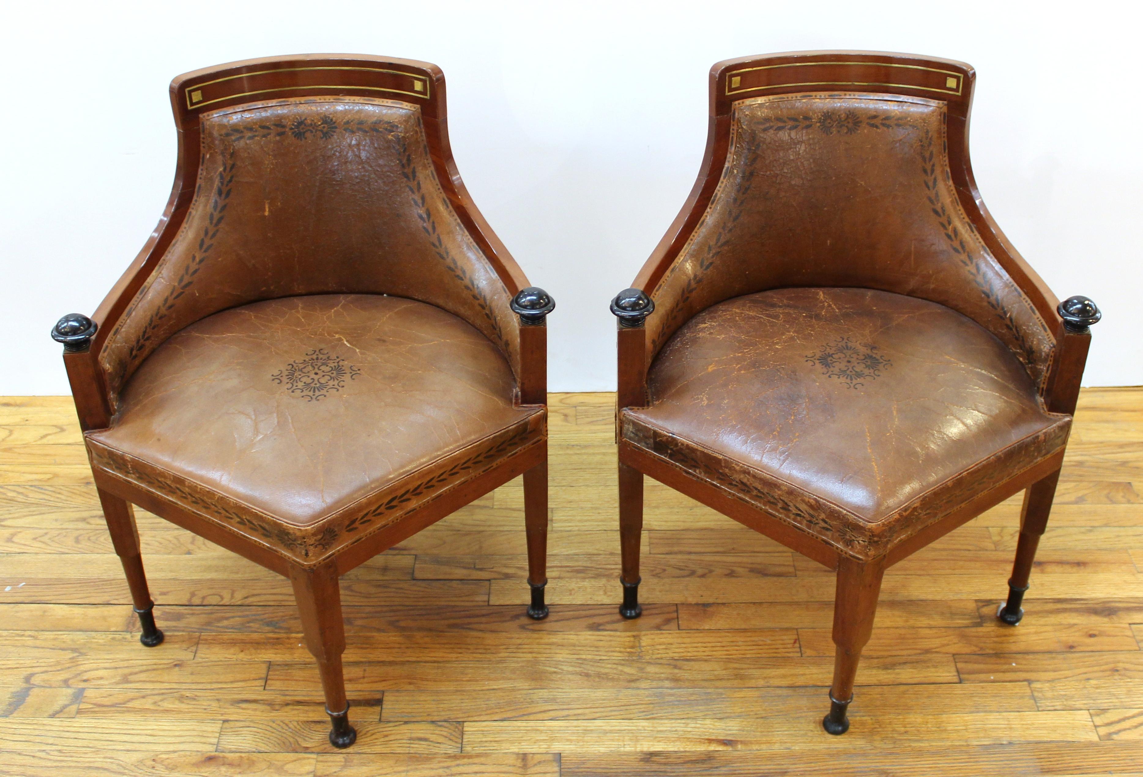 Pair of Russian or Baltic Empire desk chairs or corner chairs with curved backs in partly ebonized wood with metal inlay elements, the upholstered seat raised on square legs tapering to turned legs at the front, with ebonized sabots. Upholstered in