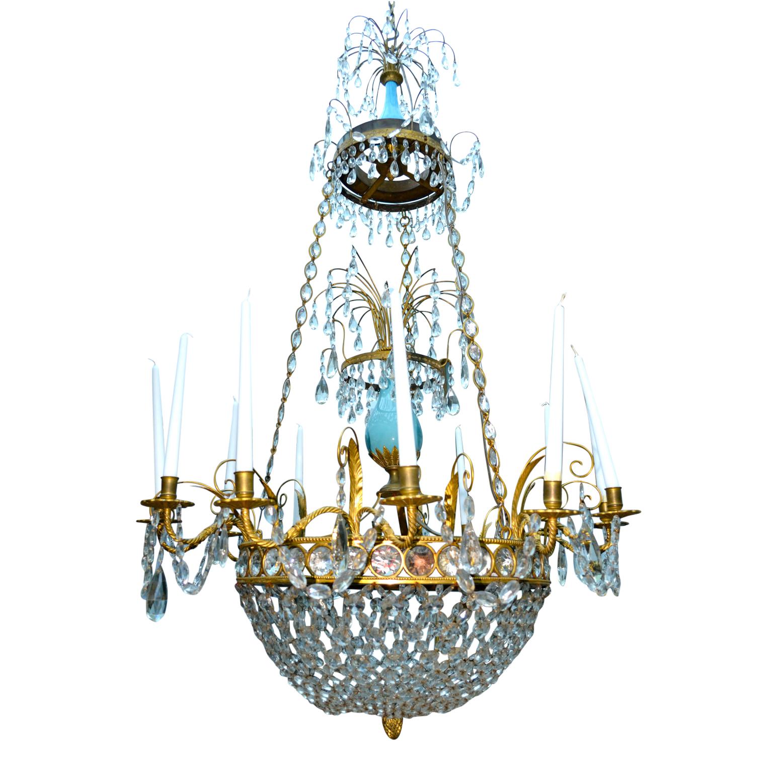 A rare late 18th century Russian or possible Prussian neo-classical chandelier, having twelve arms around a central gilded bronze corona pierced with round cut crystals; the corona suspended from three gilded chains pierced with crystals; the lower