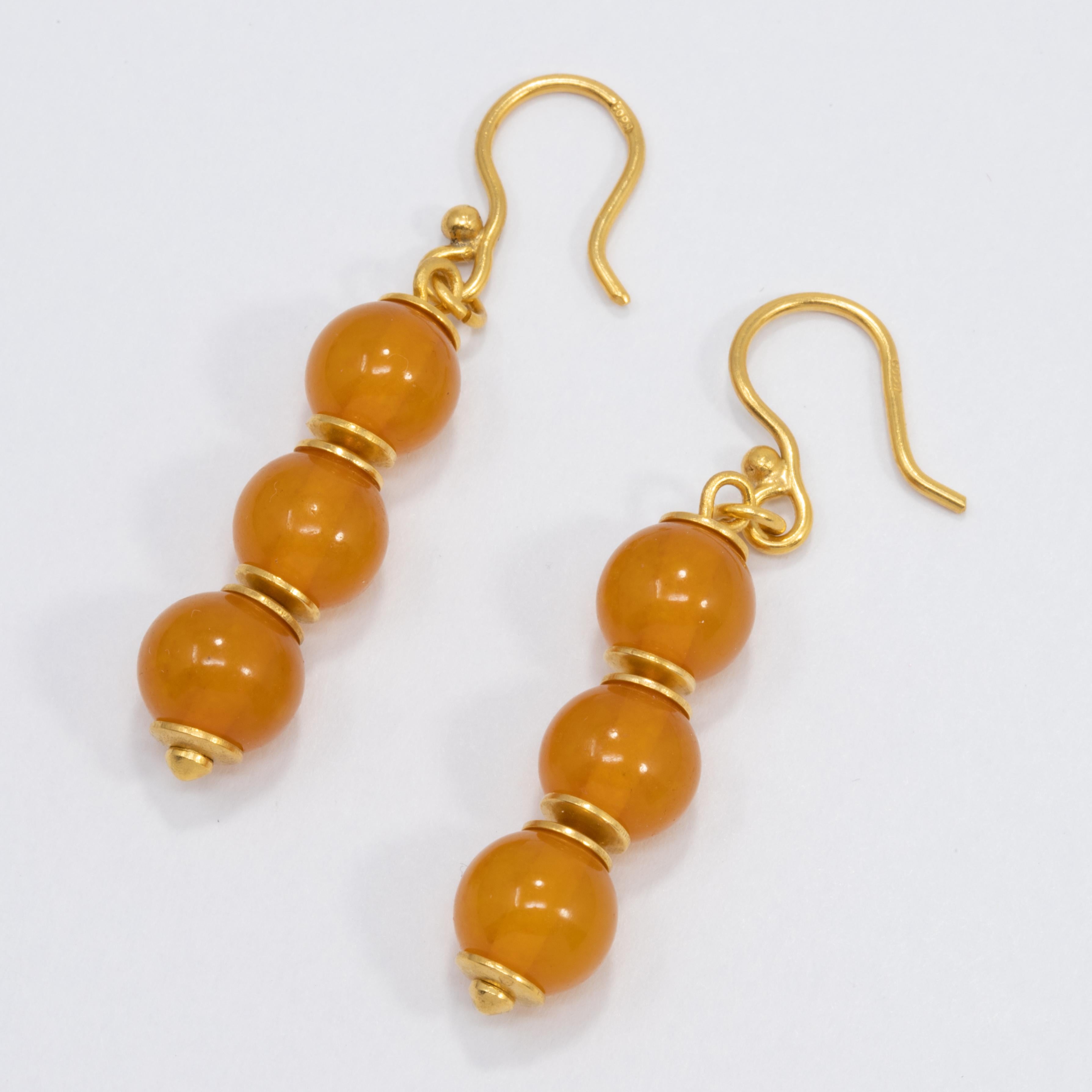 A pair of exquisite Russian earrings. Each earring features three Baltic amber beads in a rich orange color, accented with goldtone accents and hooks. Stylish!

Hallmarks: Cyrillic markings
Amber beads approx 8mm in diameter