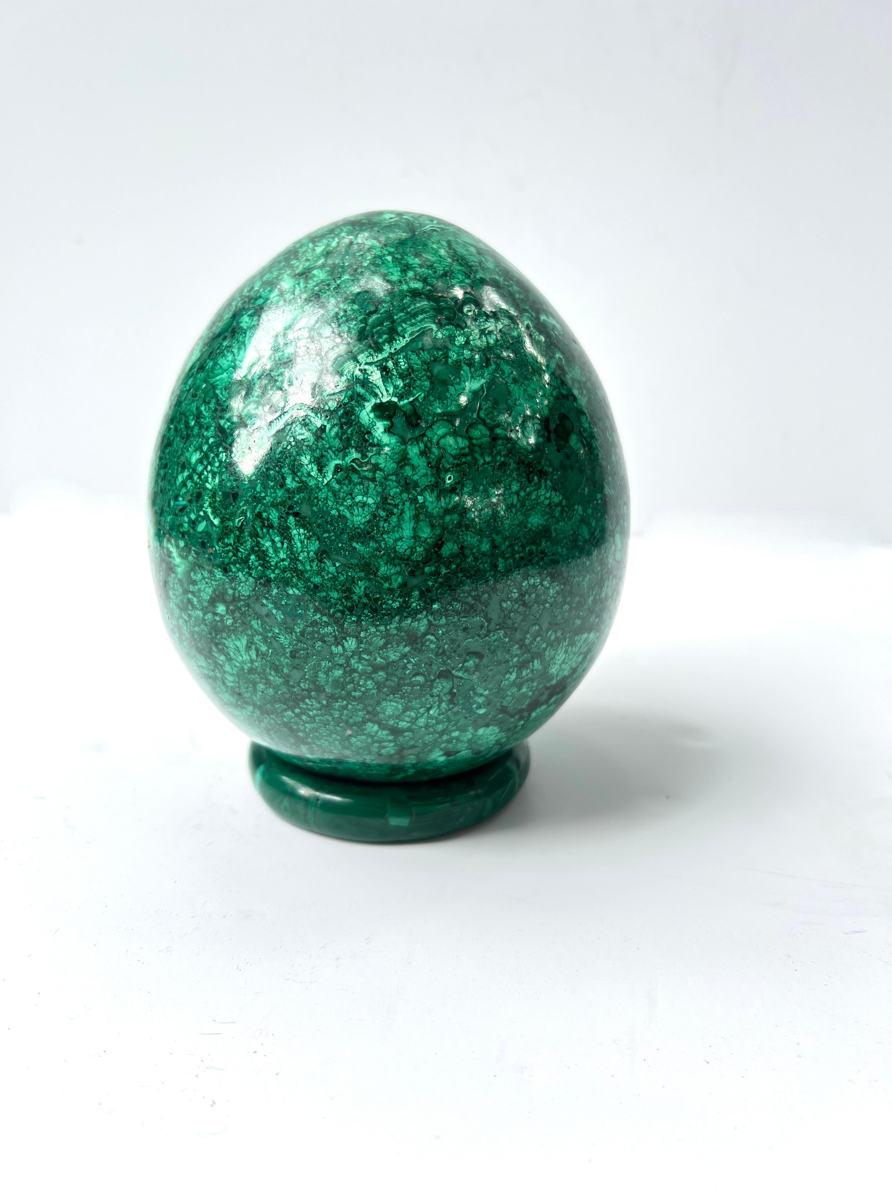 A stunning example of Russian Malachite in the form of an egg.  The malachite is very heavy at 7 pounds and rests on a Malachite form - which may be use as a bracelet.  (We have shown the piece on other brass stands, which are available, but come