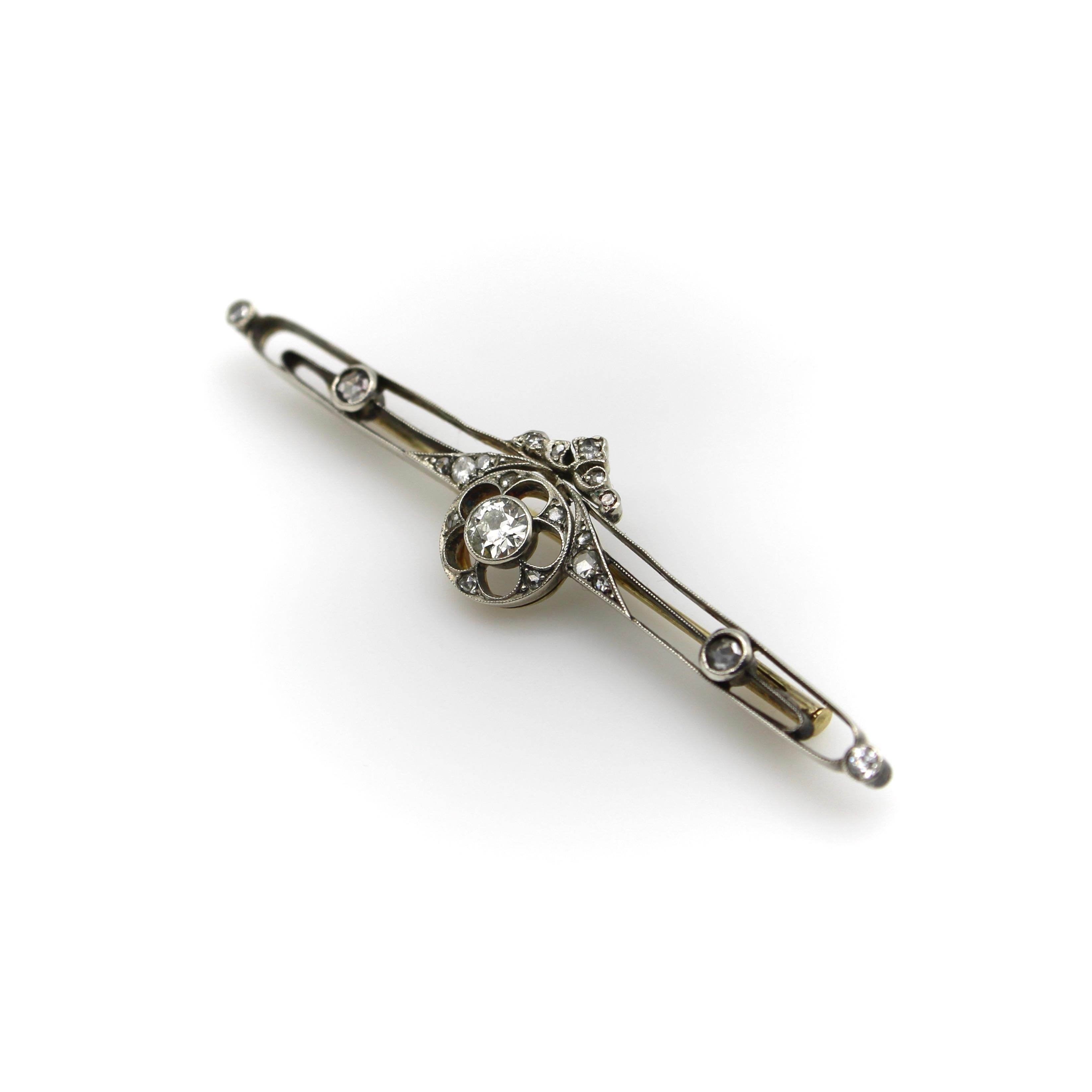 This diamond encrusted bar pin dates to 1900’s pre-revolutionary Russia. The center Old European Cut diamond is bezel set with beautiful milgrain work around it. Set in a larger circle element, the diamond is surrounded by cut outs in the shape of a
