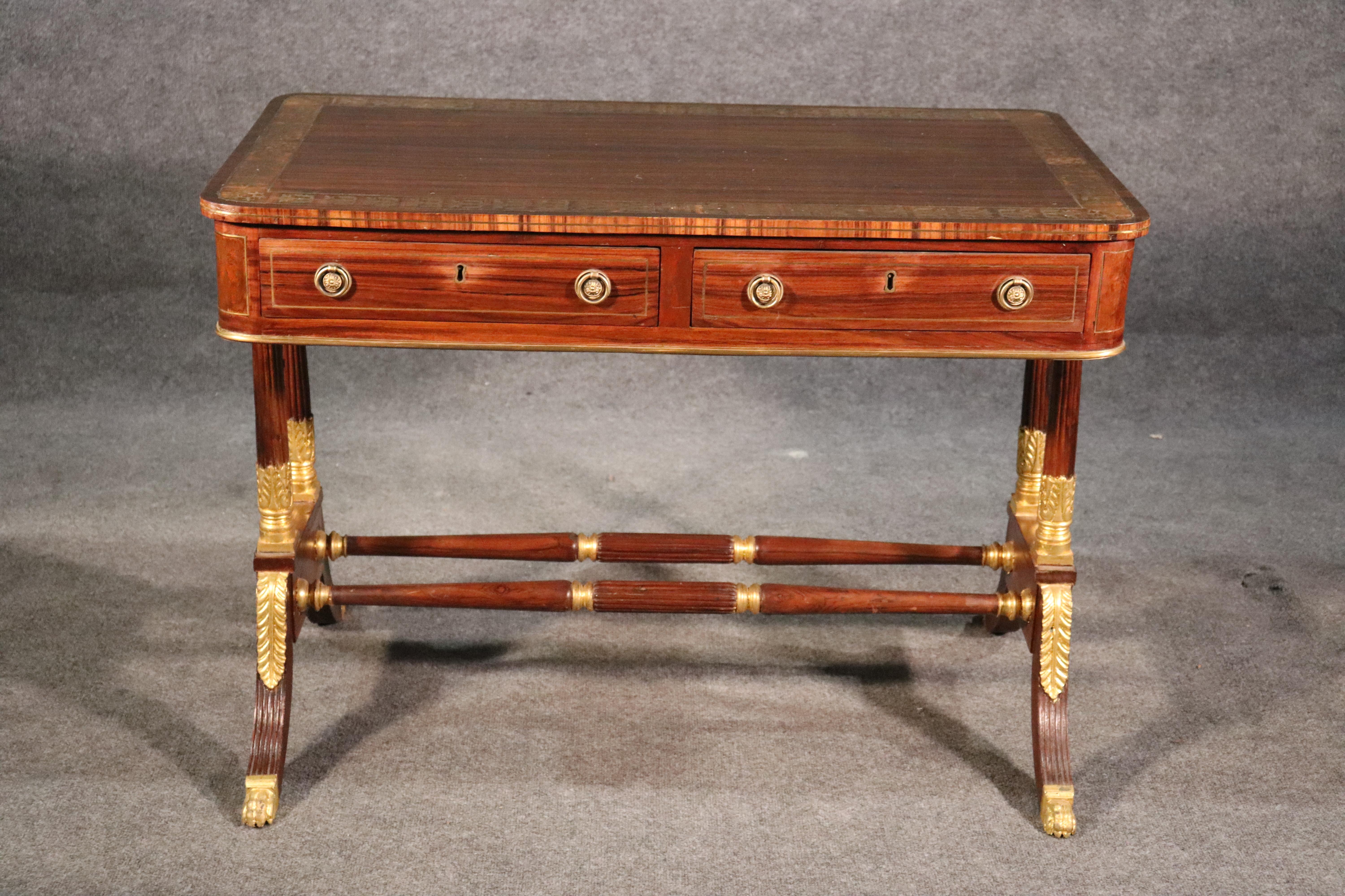 This is a superb Boulle brass inlaid rosewood Russian writing desk. The desk is made of solid rosewood and features faux rosewood paint decorating. The desk is Russian and dates to the late 1800s era and is in the Empire taste. The gold leaf is done