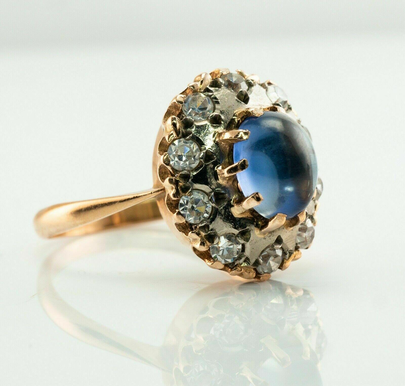 This ring has been made in Soviet Russia, Armenia. Circa 1980s.
The ring is crafted in solid 14K Pink Gold and 14K White gold for the top and has all USSR hallmarks.  
The center synthetic blue Sapphire cabochon measures 8mm x 6mm.
Ten white and