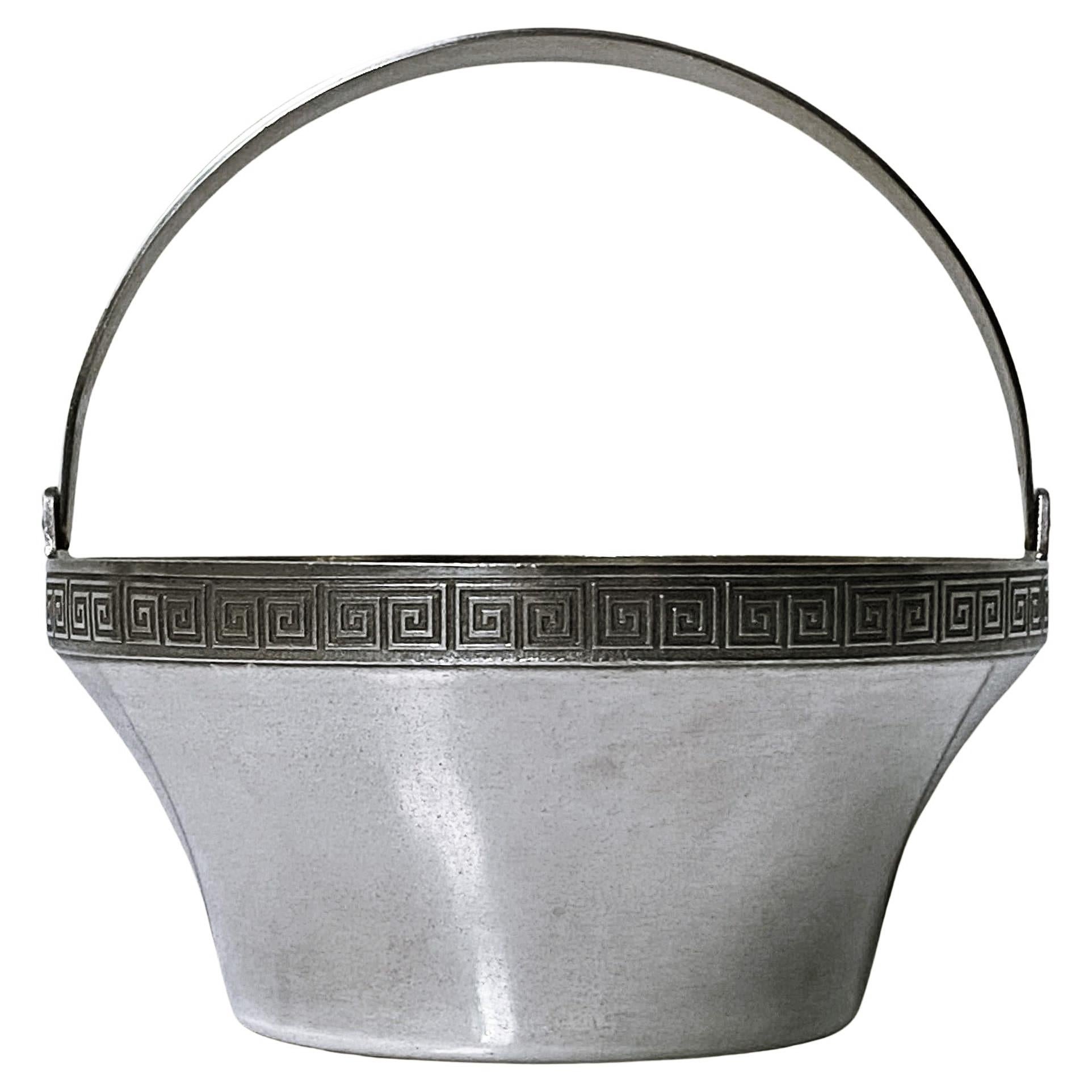 Russian silver basket circa 1940. Hammer & Sickle Mark 0.916 purity. Swing handle basket with Greek key design border, gilded interior. Height (handle up 4.25 inches, 2 inches excluding handle). Diameter: 4.25 inches. Weight: 191 grams. Condition: