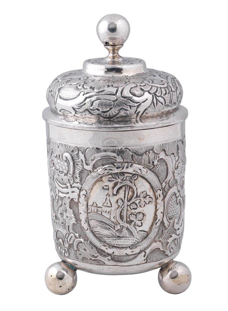 Moscow 1759
Cylindrical, on three ball feet, the cup with flat-chased scrolling leaves, the low-domed cover with similar flat-chasing, with a ball finial, marked under base
Measure: Height 16.5cm
Weight : 215gr.