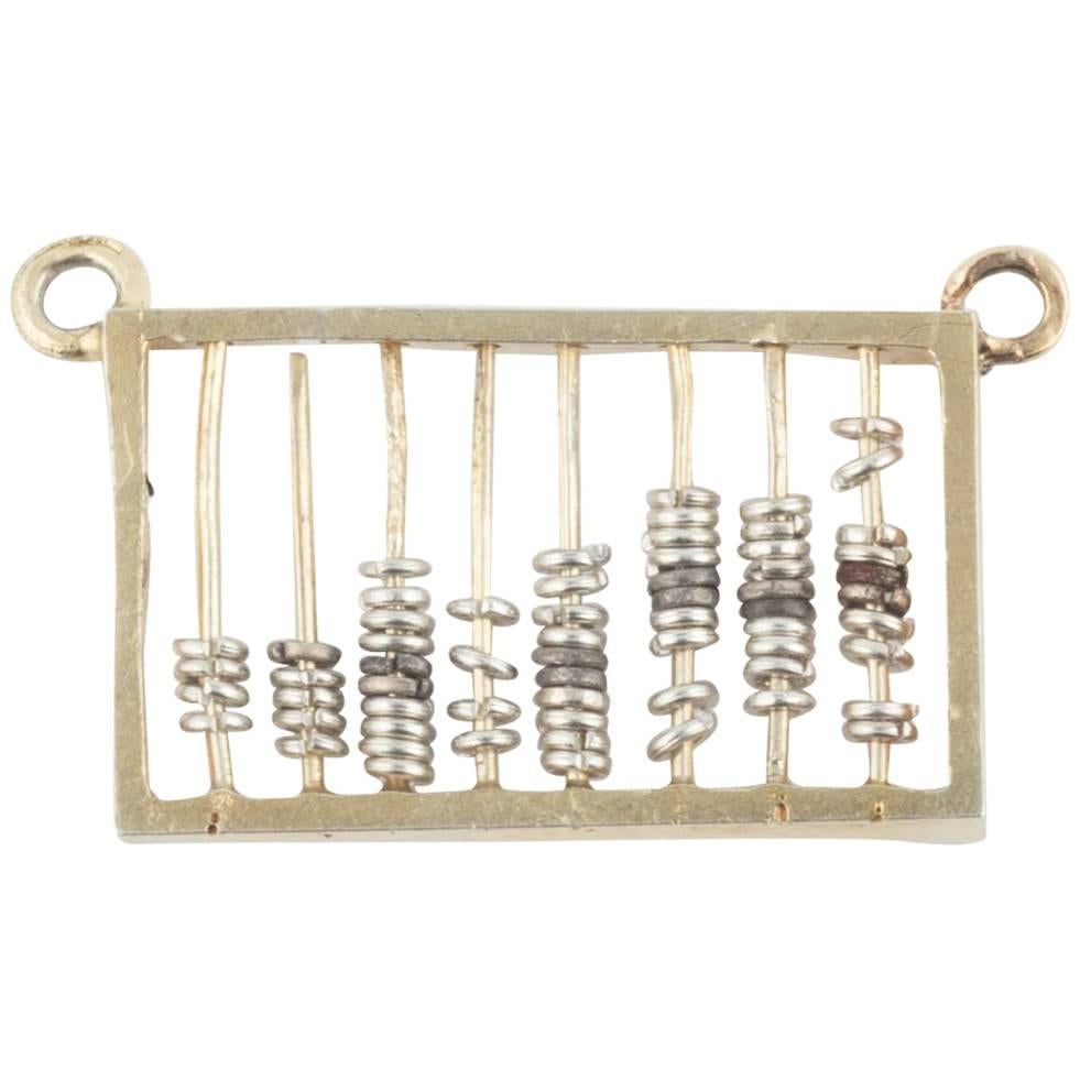 From the Romanov era period of Tsar Nicholas II, designed as a silver-gilt abacus with silver rings, some oxidized to provide contrasts, each strung on bars within a gilded frame.

Stamped 84, the Russian silver standard and stamped with the