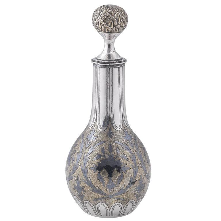 Apparently unmarked but Russia, circa 1820 

Elongated compressed oval, decorated with floral garlands within similar borders on gilt stippled ground, the screw top with ball finial chased with foliate decorations. 

Height: 17.5 cm
Weight: 172.8 gr