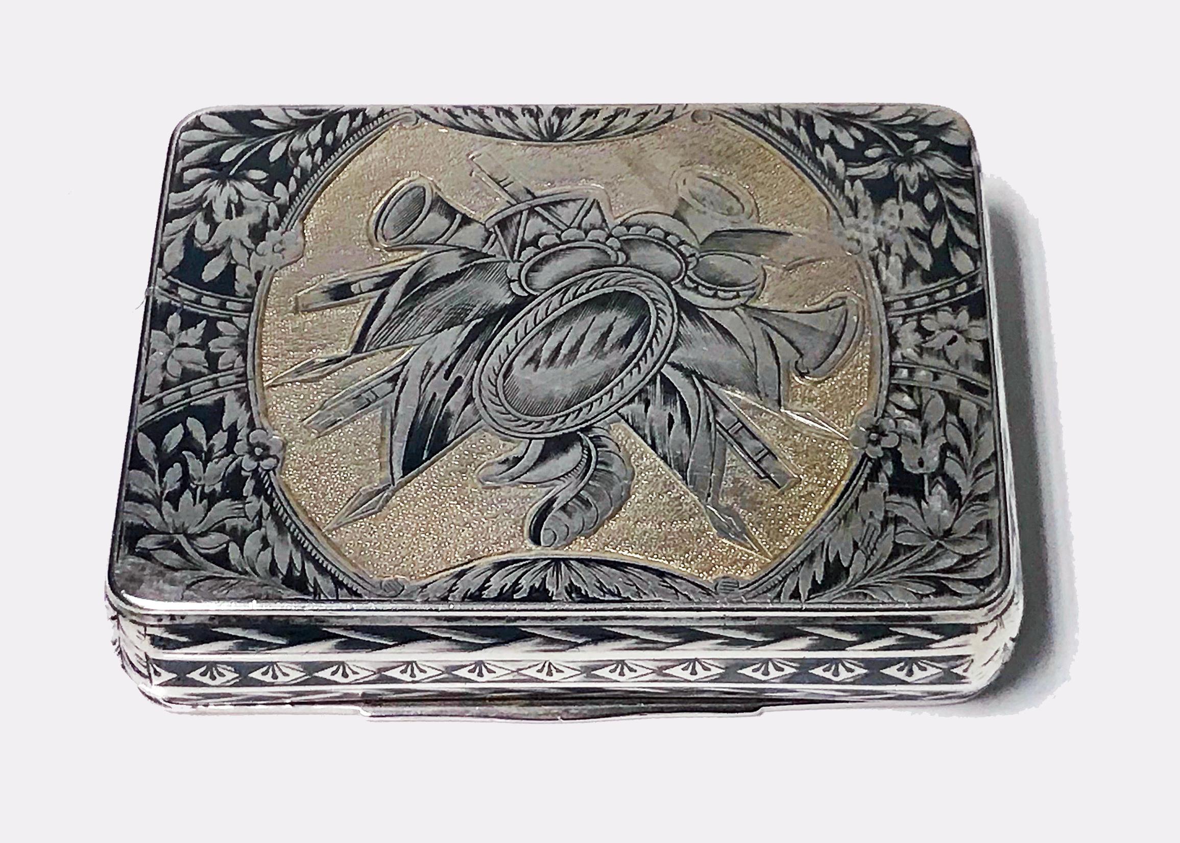 Fine Russian Silver Niello Snuff Box, assayer Nikolaì Lukich Dubrovin 1824. The hinged cover decorated with the Bronze Horseman, Peter The Great on rock against stippled scale work background with foliate surround and inscribed with Cyrillic Peter 1