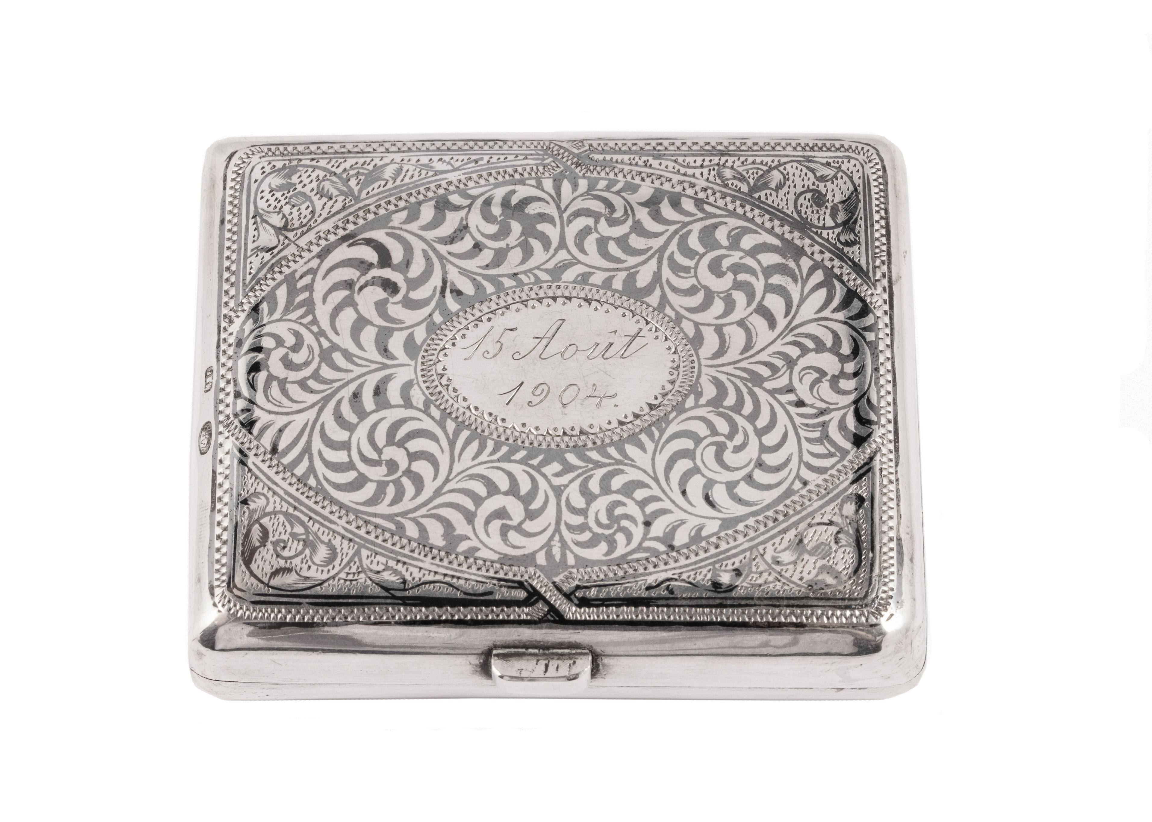 Russian nielloed silver box from the Romanov era, period of Tsar Nicholas II, with rounded corners, overall nielloed with scrolling foliage, displaying a central scene of a Moscow cityscape, the reverse with further scrolling decoration in niello.