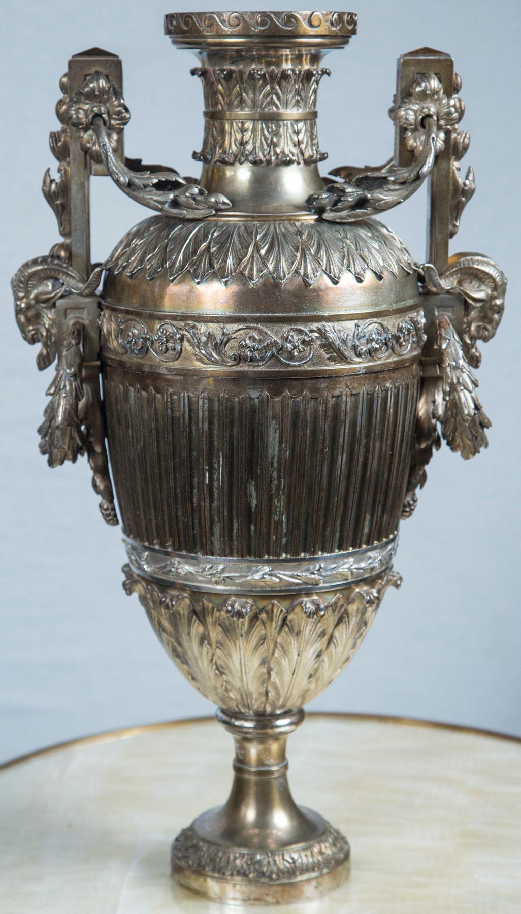 Probably Russian, 18th-19th century. Z marks on handles. Rams heads with laurel wreaths. Winged head of a female on centre of one side. Decorated with laurel leaves and swags. Cast in two parts, handles cast separately.