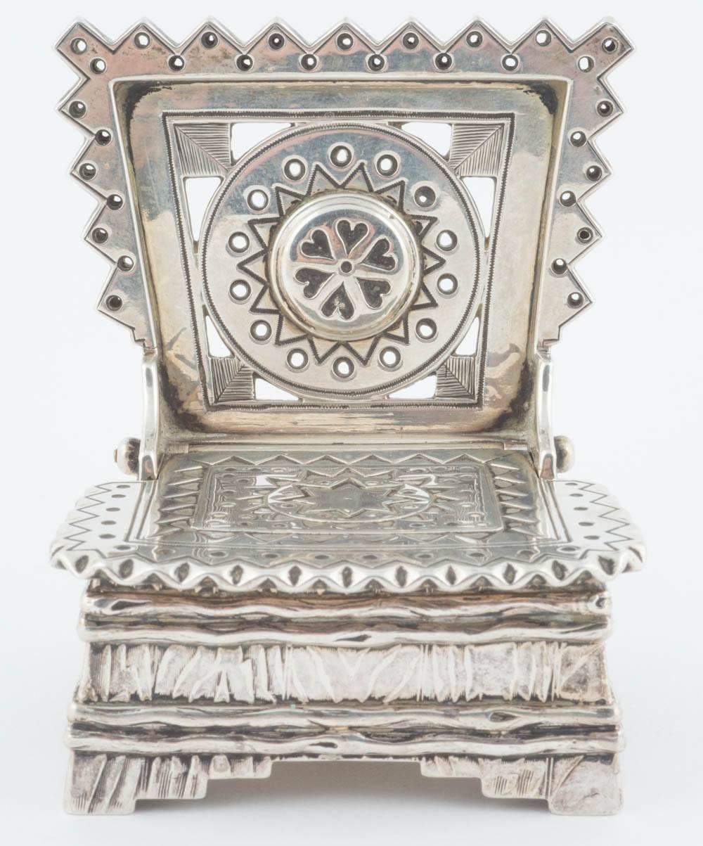 Of typical Old Russian design this rare and distinctive silver salt cellar in the shape of a throne is from the Romanov era, period of Tsar Alexander III.  The surface simulates wooden bark, the hinged lid and pierced back decorated with star, heart