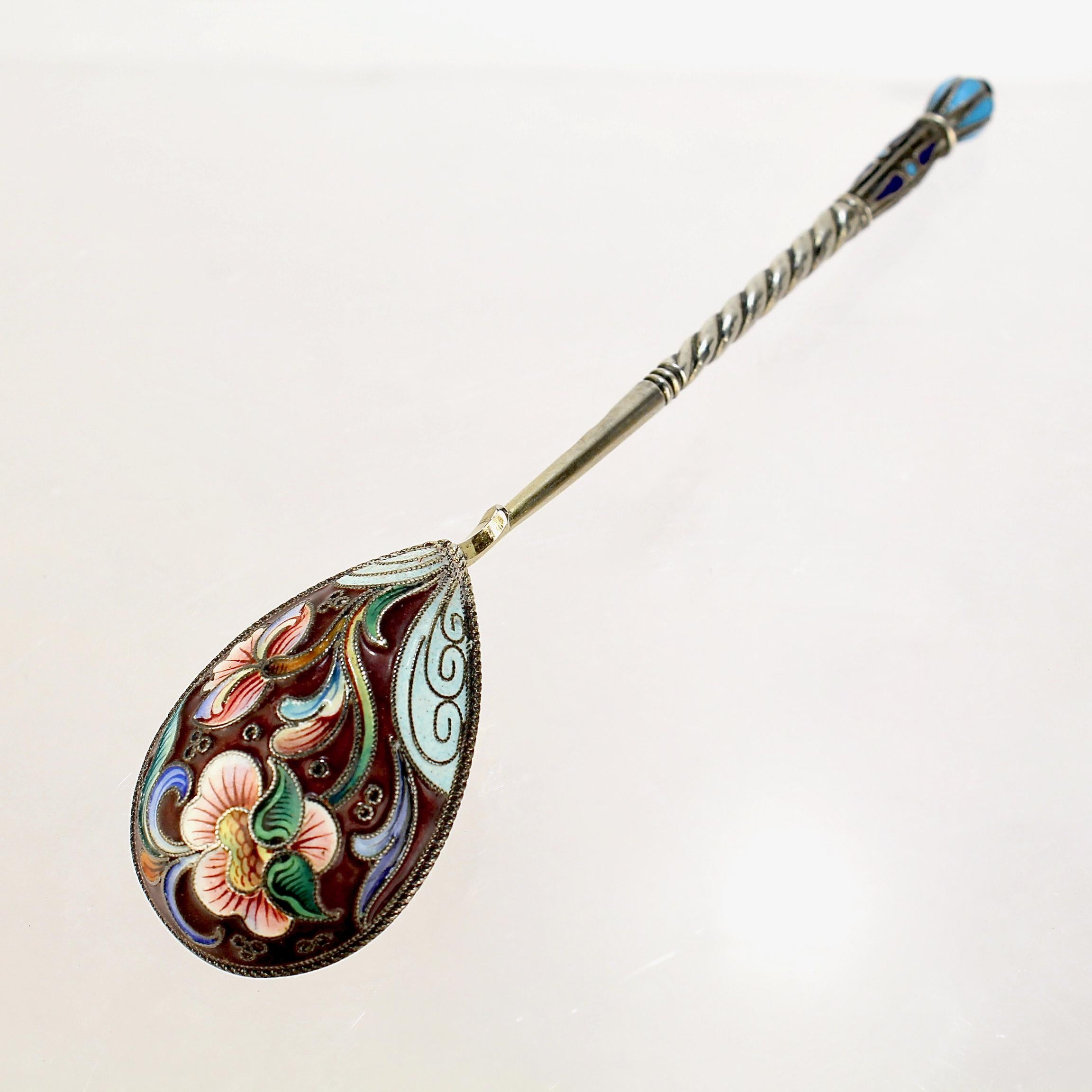 A very fine antique Russian tea or kvosh spoon.

By Maria Sokolova.

With polychrome shaded cloisonné enamel decoration to both the front and reverse.

Simply a wonderful piece of Imperial Russian silver!

Date:
Late 19th or Early 20th