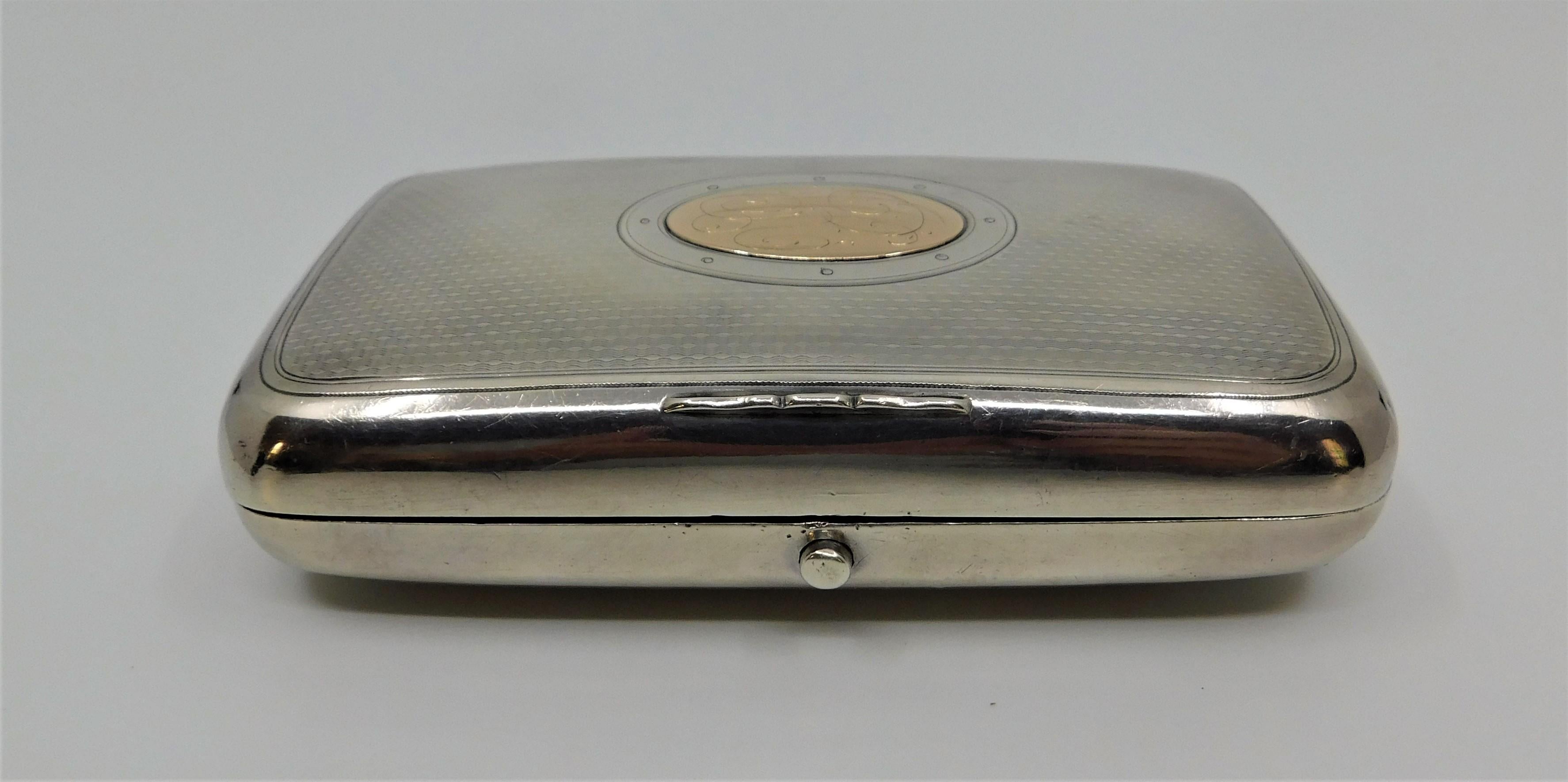Early 20th century made in Russia silver cigarette case with a gold monogrammed central medallion.