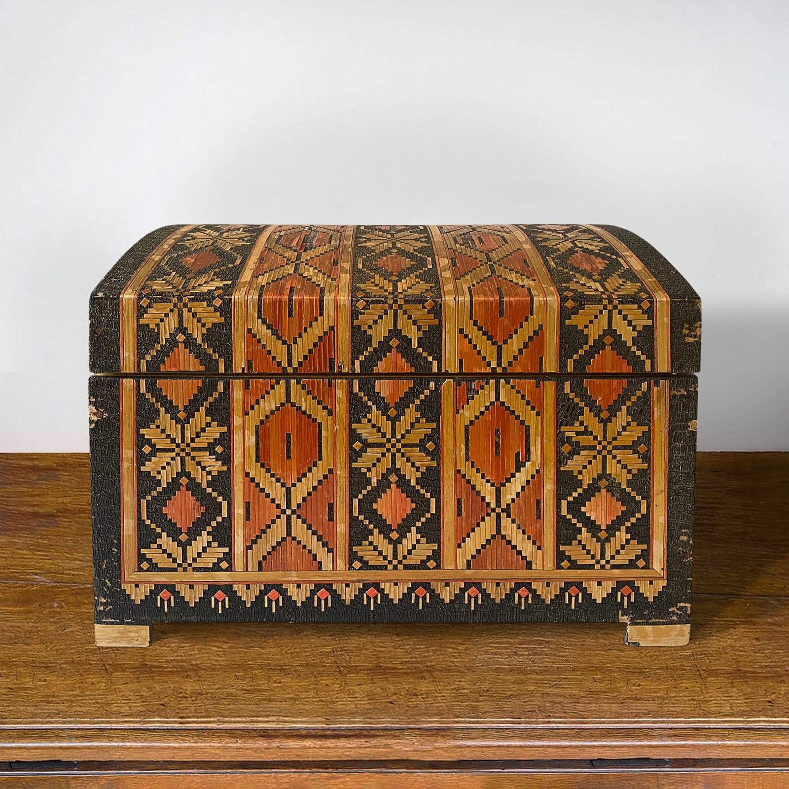 Dome topped table coffer veneered with traditional Russian designs in straw marquetry.
This is a rare and vibrant object in rather careworn condition. Condition report available.
Russian 1920s.
Measures: 24cms H x 35cm Wx 25cm D.