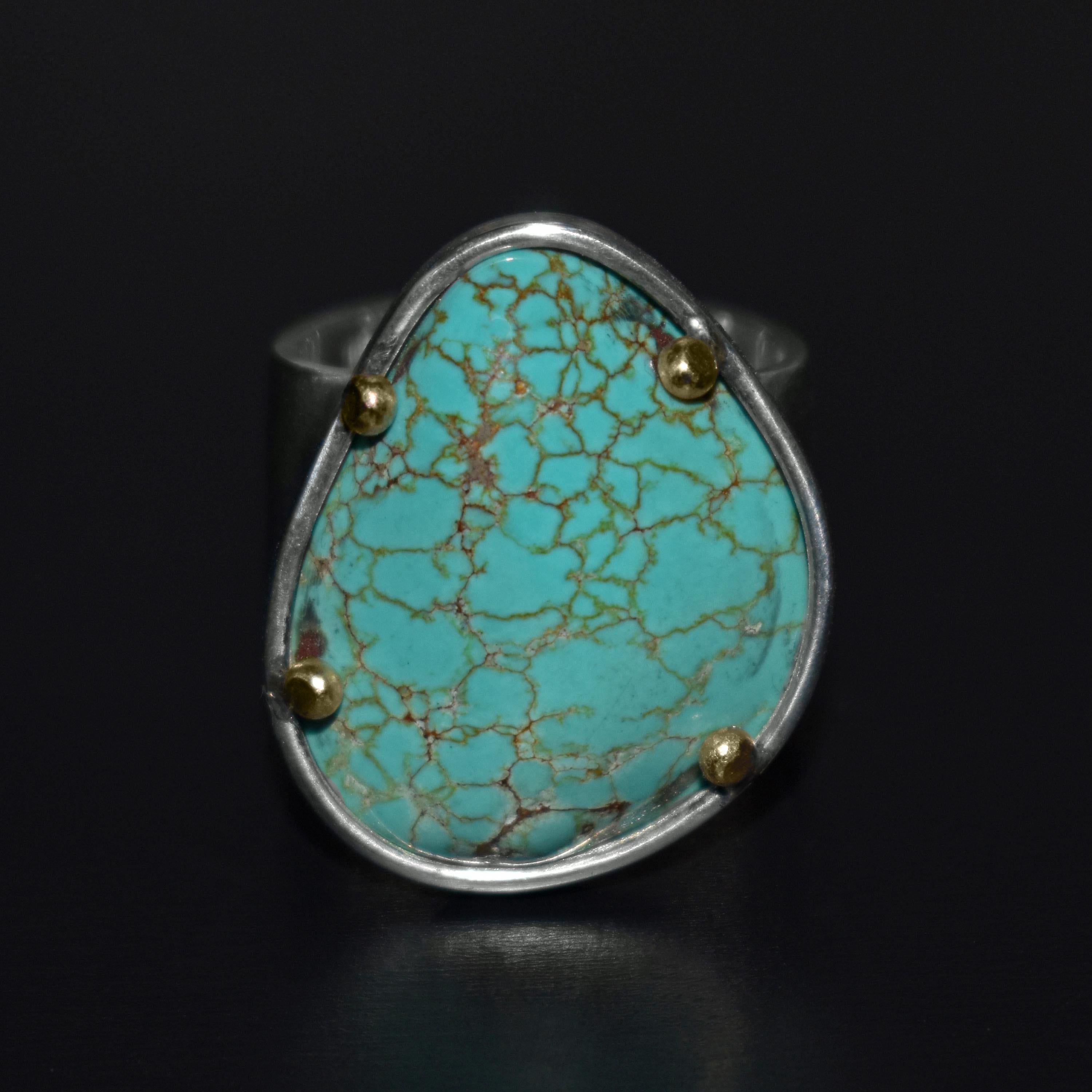 Handmade sterling silver with 14k yellow gold cocktail ring featuring a gorgeous, natural Russian Turquoise gemstone. Ring is 7.5 in size. Ring band is 0.5 inches wide. Stone measures 0.94 inch length by 0.81 inch width.