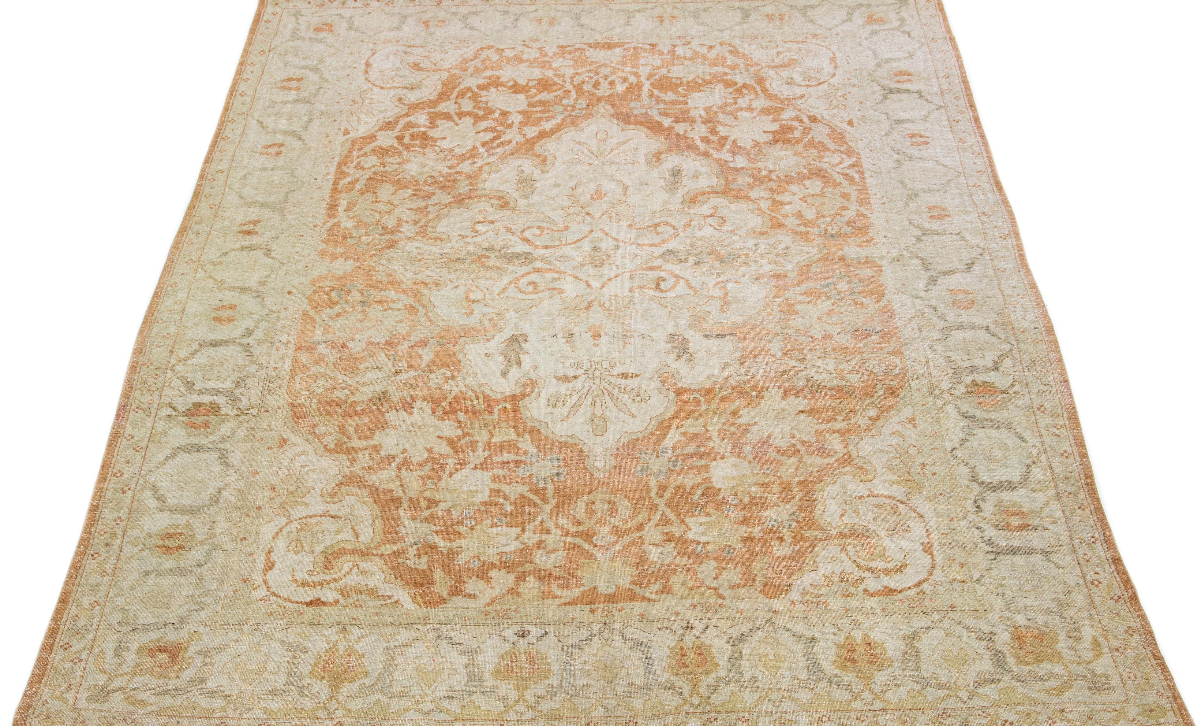 This exquisite hand-knotted Agra wool rug features a rust field accented by beige and gray motifs in a timeless medallion floral pattern.

This rug measures: 8.11